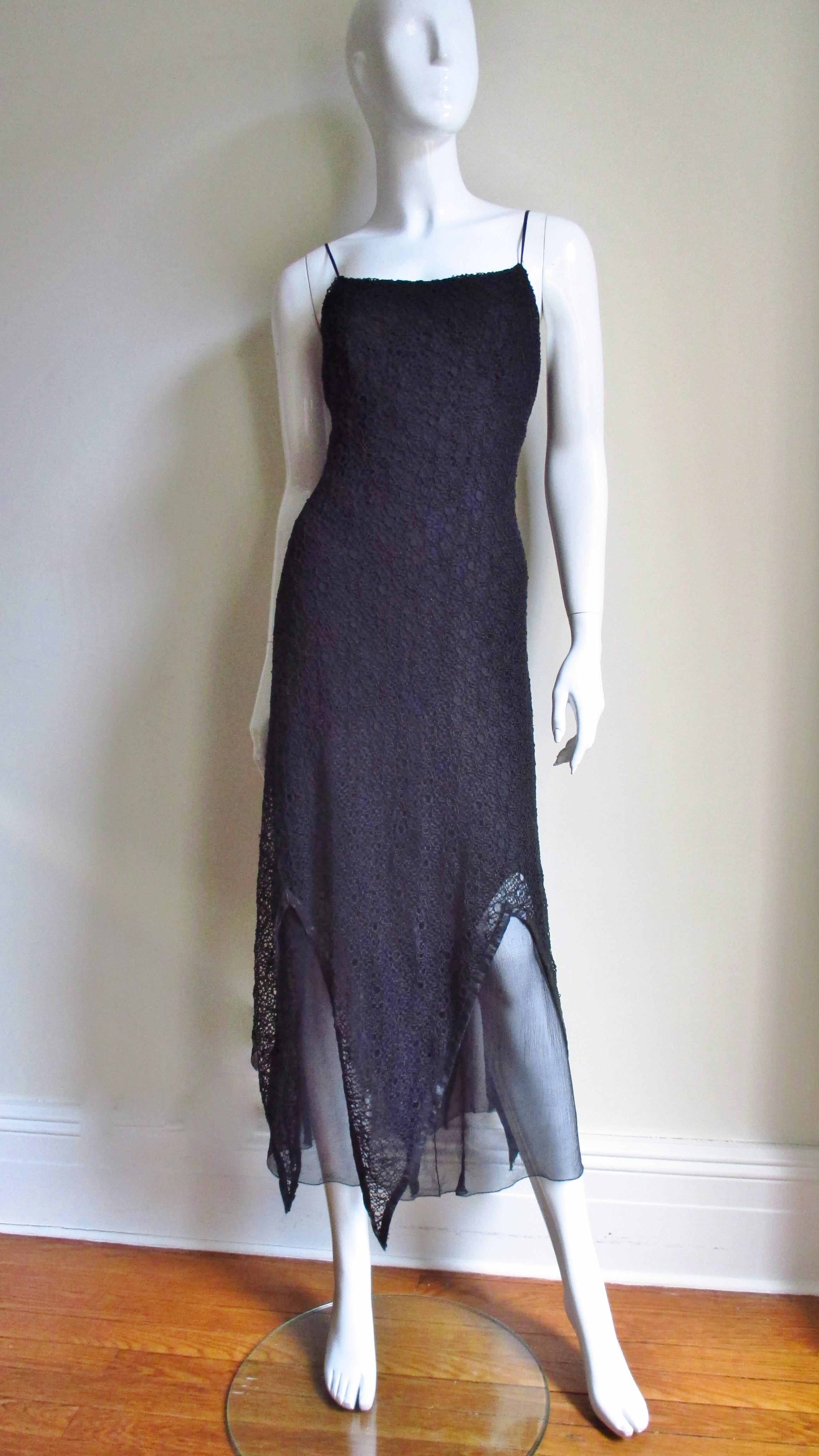A fabulous black silk slip style dress by Karl Lagerfeld. It consists of 3 layers- the top of lace with a leather trimmed pointed hem over a layer of semi sheer silk with a straight hem over another layer of silk with a pointed hem.  Fabulous.  The