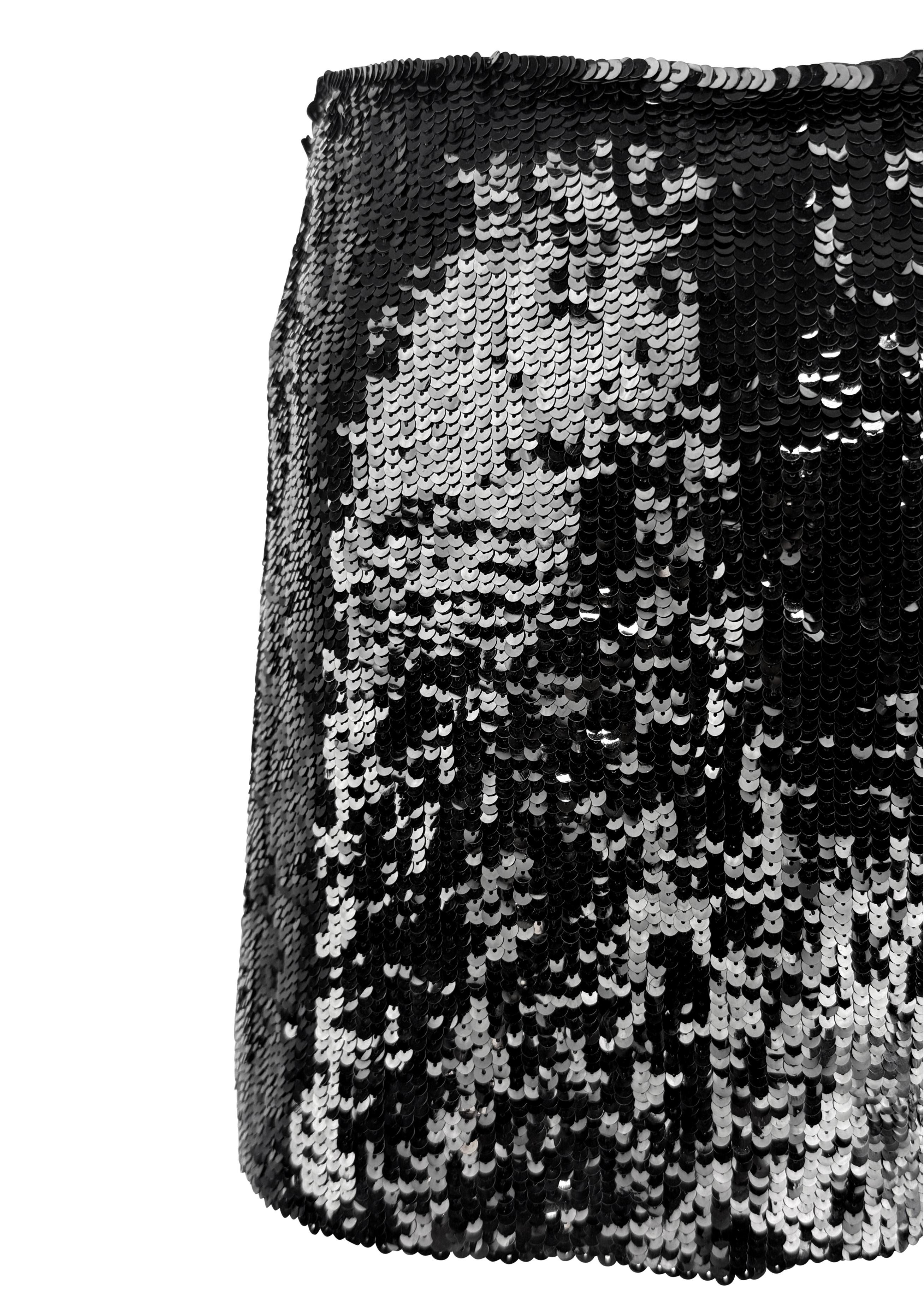 From the 1990s, this Katharine Hamnett super mini skirt is fully covered in black sequins atop a lightweight silk base. The bold, high-shine finish and ultra-short cut reflect the era’s clubwear energy and Hamnett’s rebellious design
