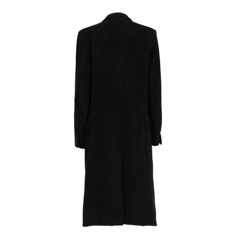Katharine Hamnett long black wool coat. Peak lapel collar, padded shoulders, double breasted closure. Two external welt flap pockets and two inside pockets.

Size: M

Flat measurements
Height: 116 cm
Bust: 50 cm
Shoulders: 42 cm
Sleeves: 61