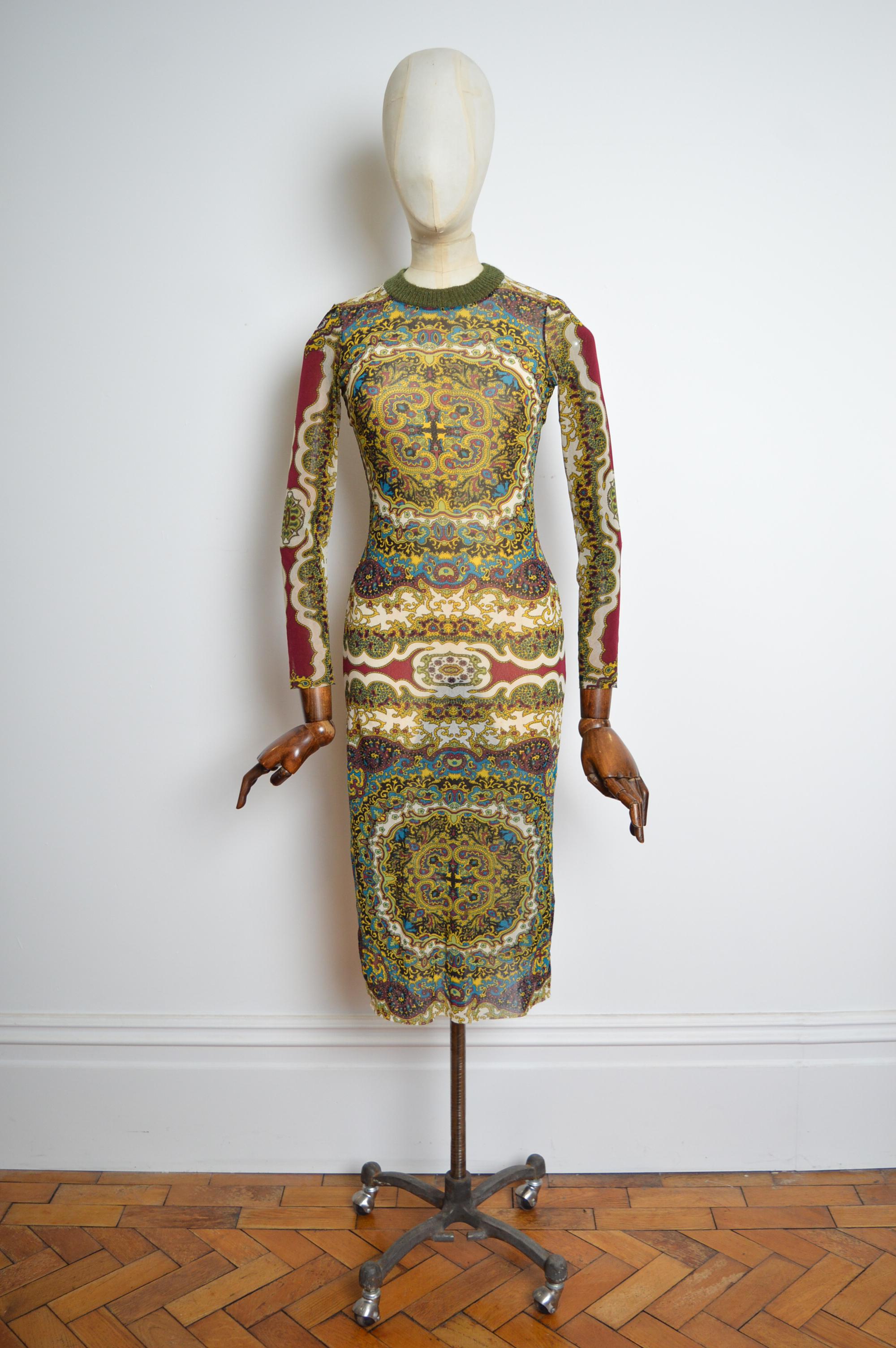 Superb 1990's Sheer Vintage Kenzo micro mesh dress in Deep tones of burnt reds and greens with an intricate Paisley print design through out and wool trimmed collar. 
Size; ONE SIZE fits U.K. 8-12.
Pit to Pit; stretchy 18-22”
Nape to Hem; 45”
Waist;