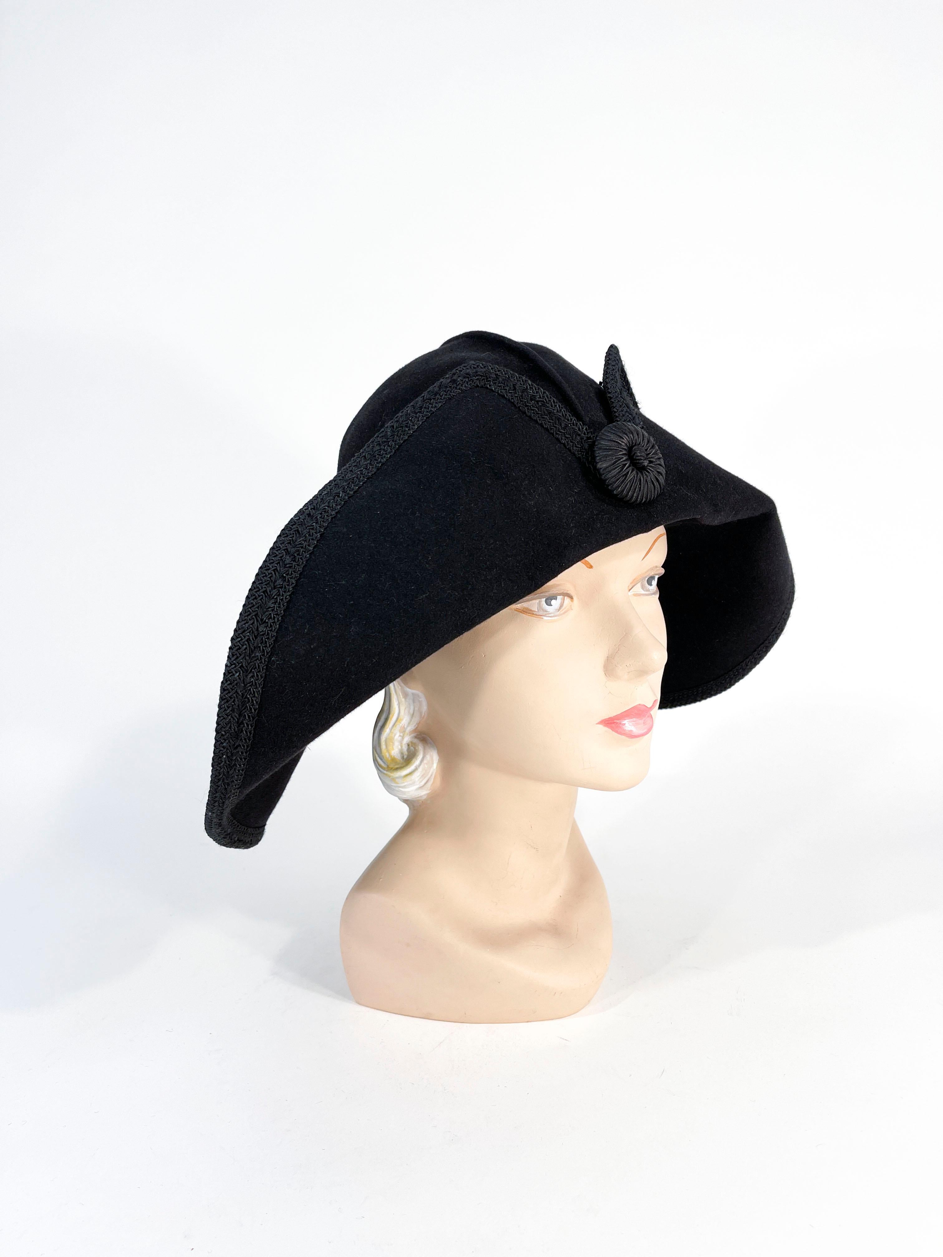 1990s Kokin black fur felt wide-brimmed hat featuring a flipped brim, hand molding crease, braided trim, and a centered cocarde. 