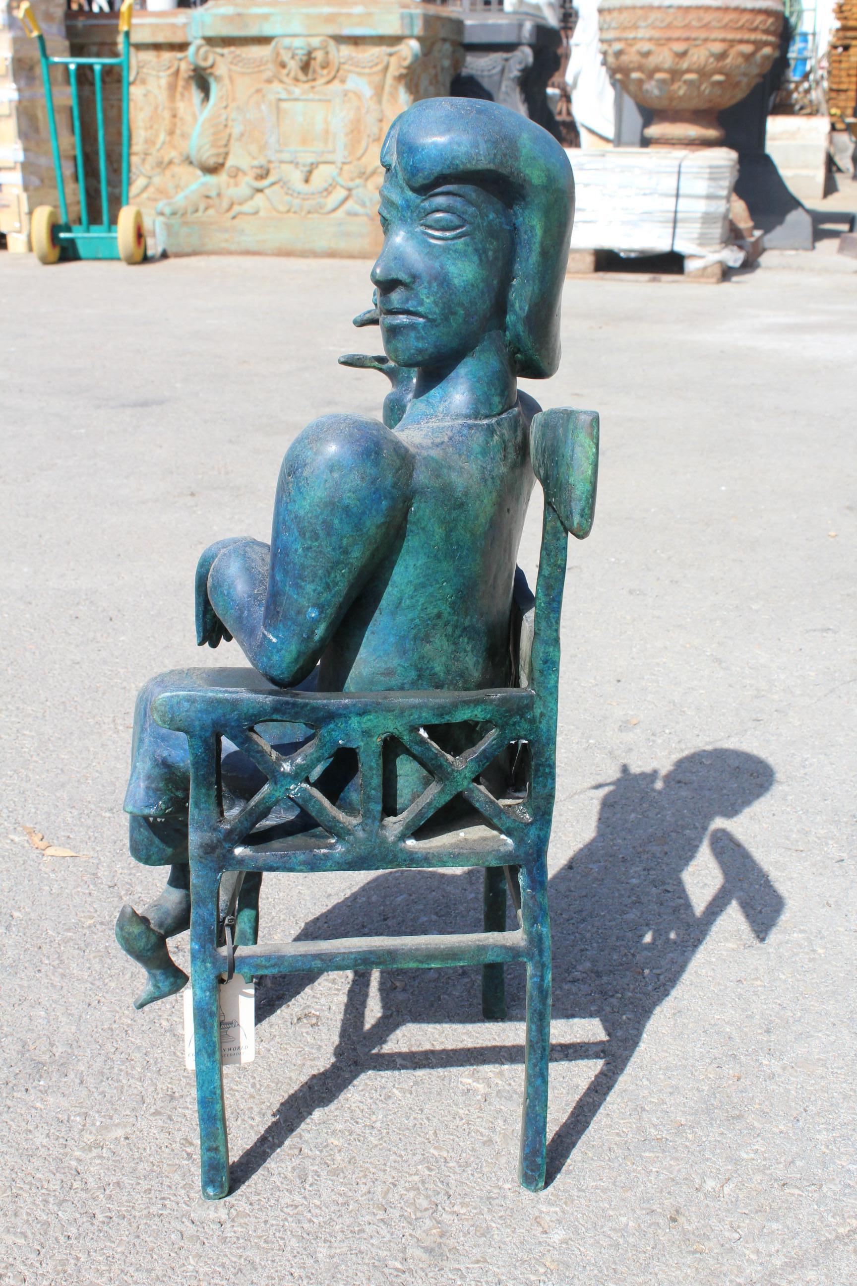 1990s Bronze abstract sculpture of a lady sitting on a chair.