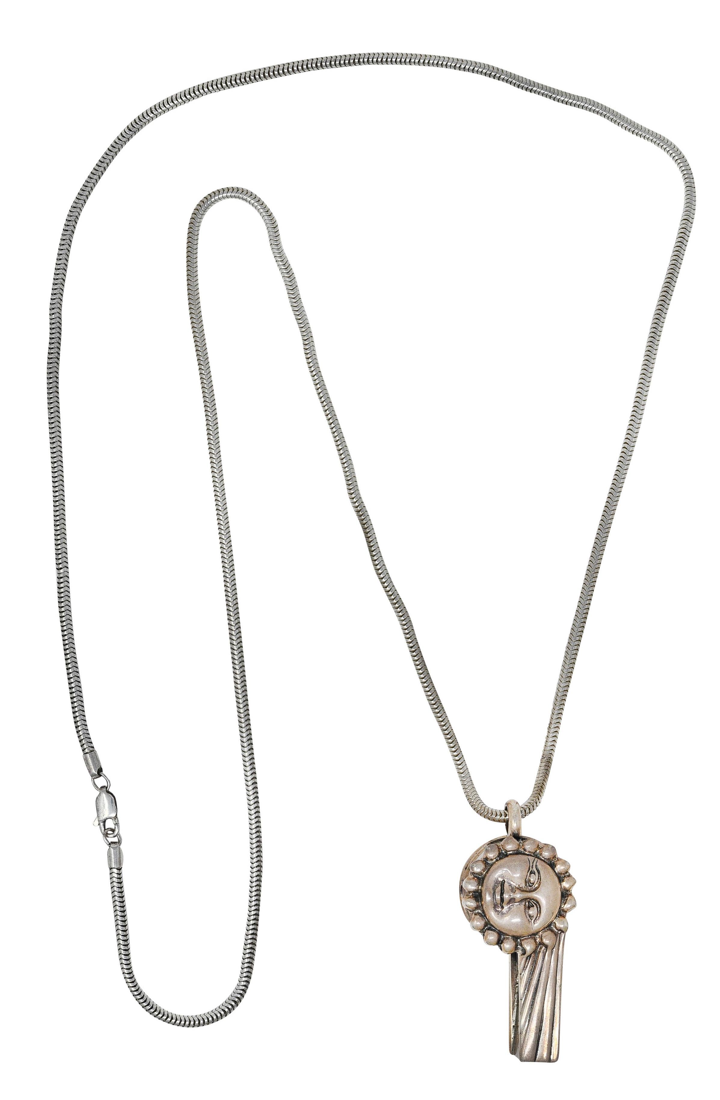 Necklace designed as functional stylized whistle pendant on 2.0 mm snake chain

Featuring deeply carved sun, moon, and star motifs on either side

Completed by lobster clasp

Stamped 925 for sterling silver

Stamped Caviar for Lagos - circa 1990's