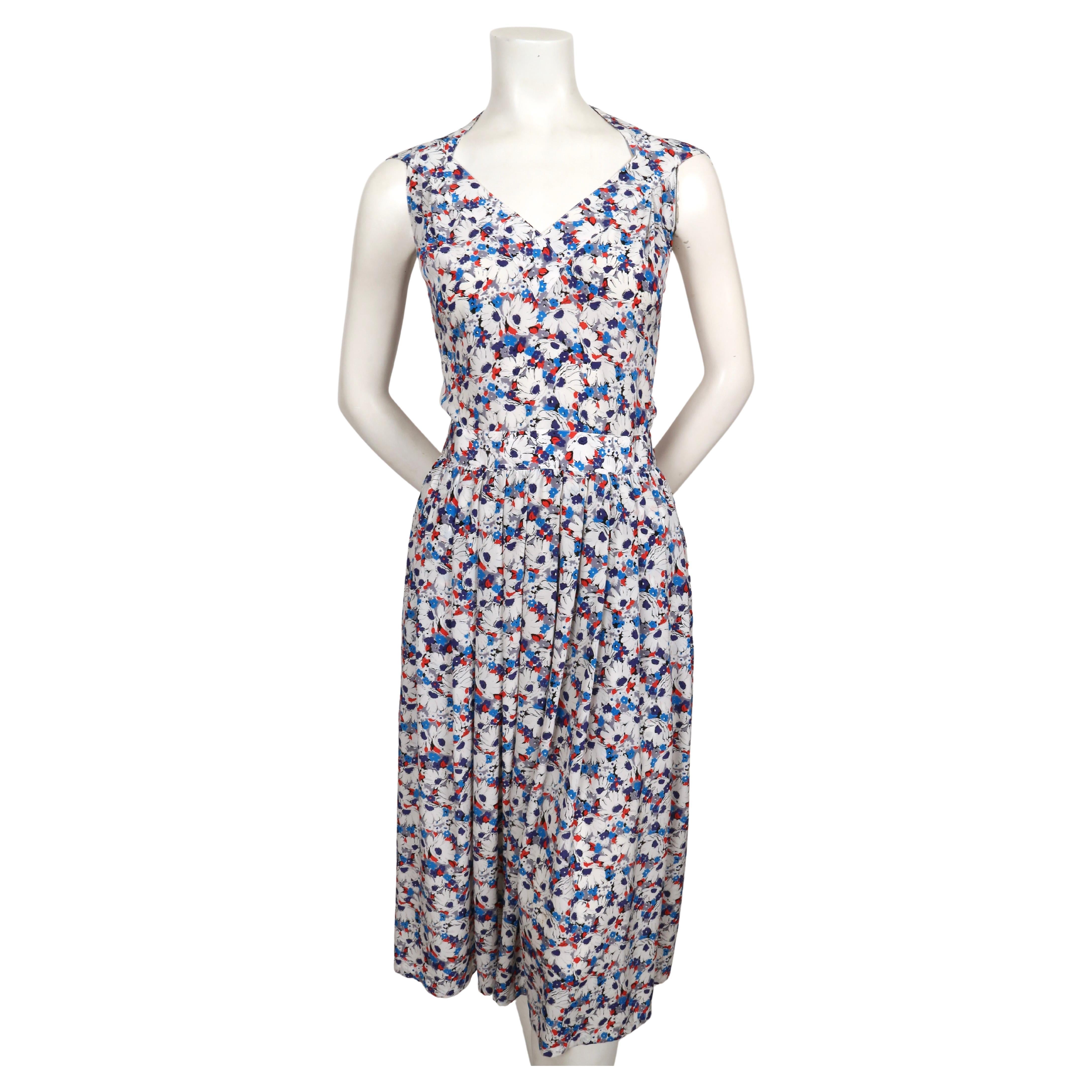 Silk, floral-printed dress with button closure and unique straps from Lanvin dating to the late 1980's, early 1990's. French size 38. Approximate measurements: bust 33.5-34