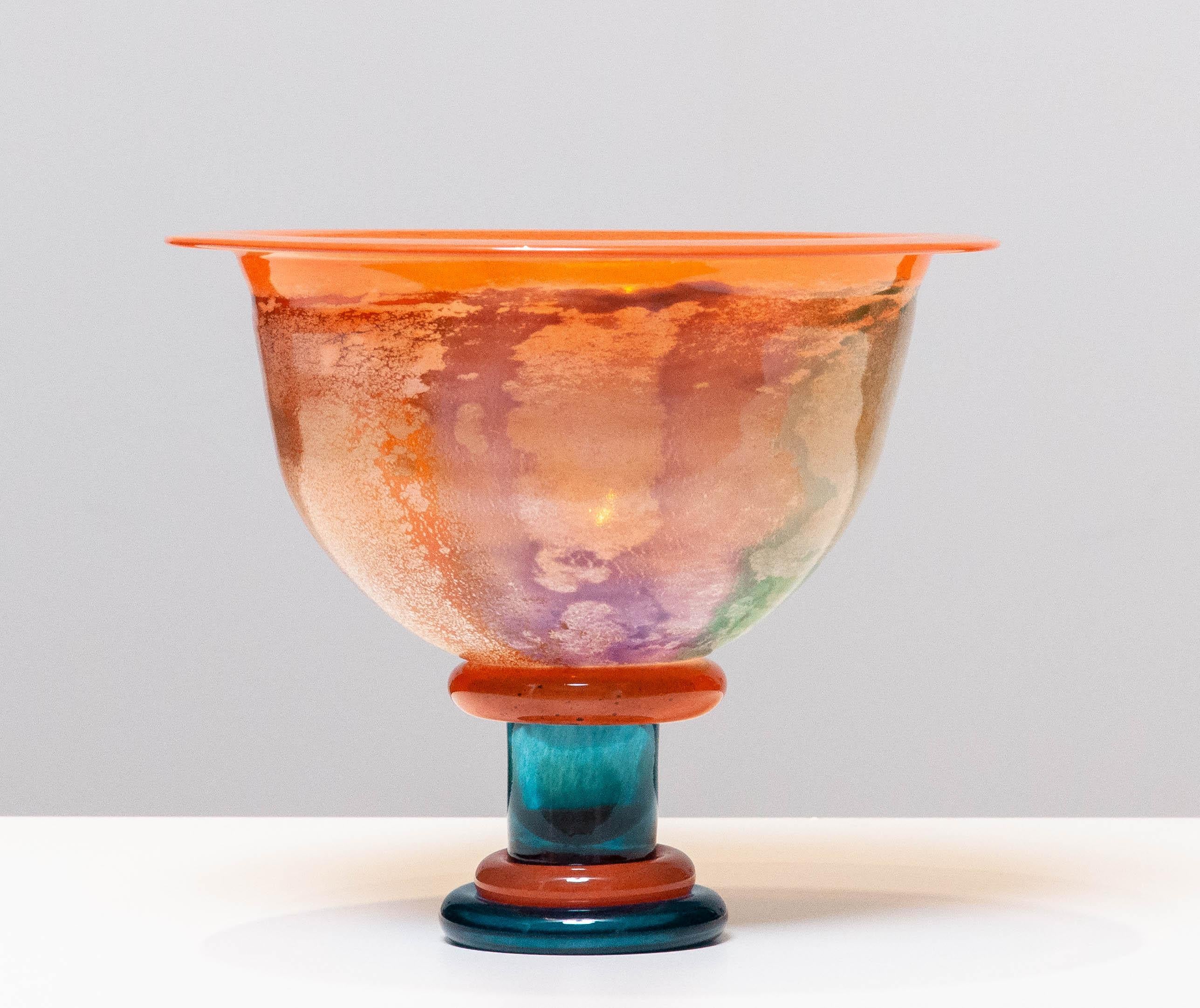 Beautiful large melange art glass in orange and blue bowl designed by Kjell Engman for Kosta Boda in the 1990's from the 'Cancan' series. Allover in very good condition.