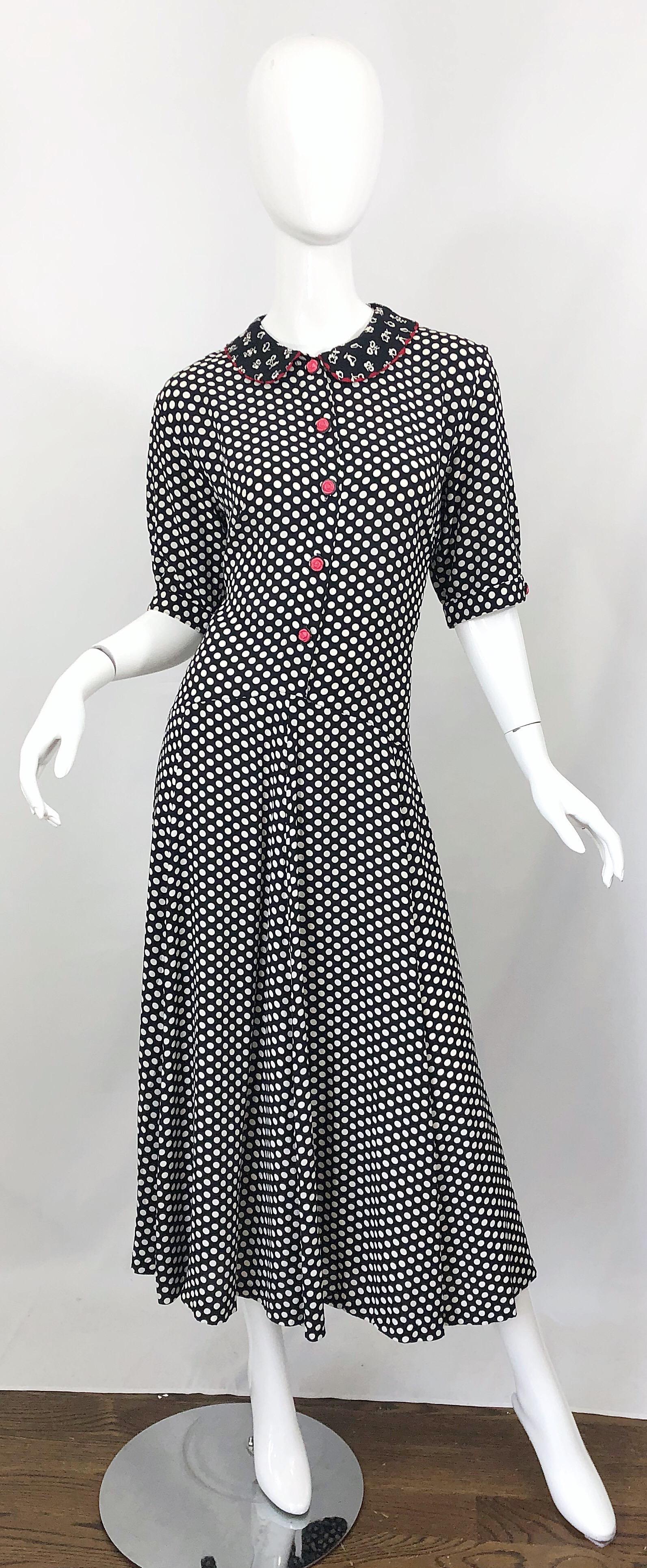 Effortlessly chic larger size 1990s black and white polka dot and novelty fruit print midi dress! Features classic black and white polka dot print on a soft rayon fabric. Cute pink rosette lucite buttons up the front and at each sleeve cuff. Fruit