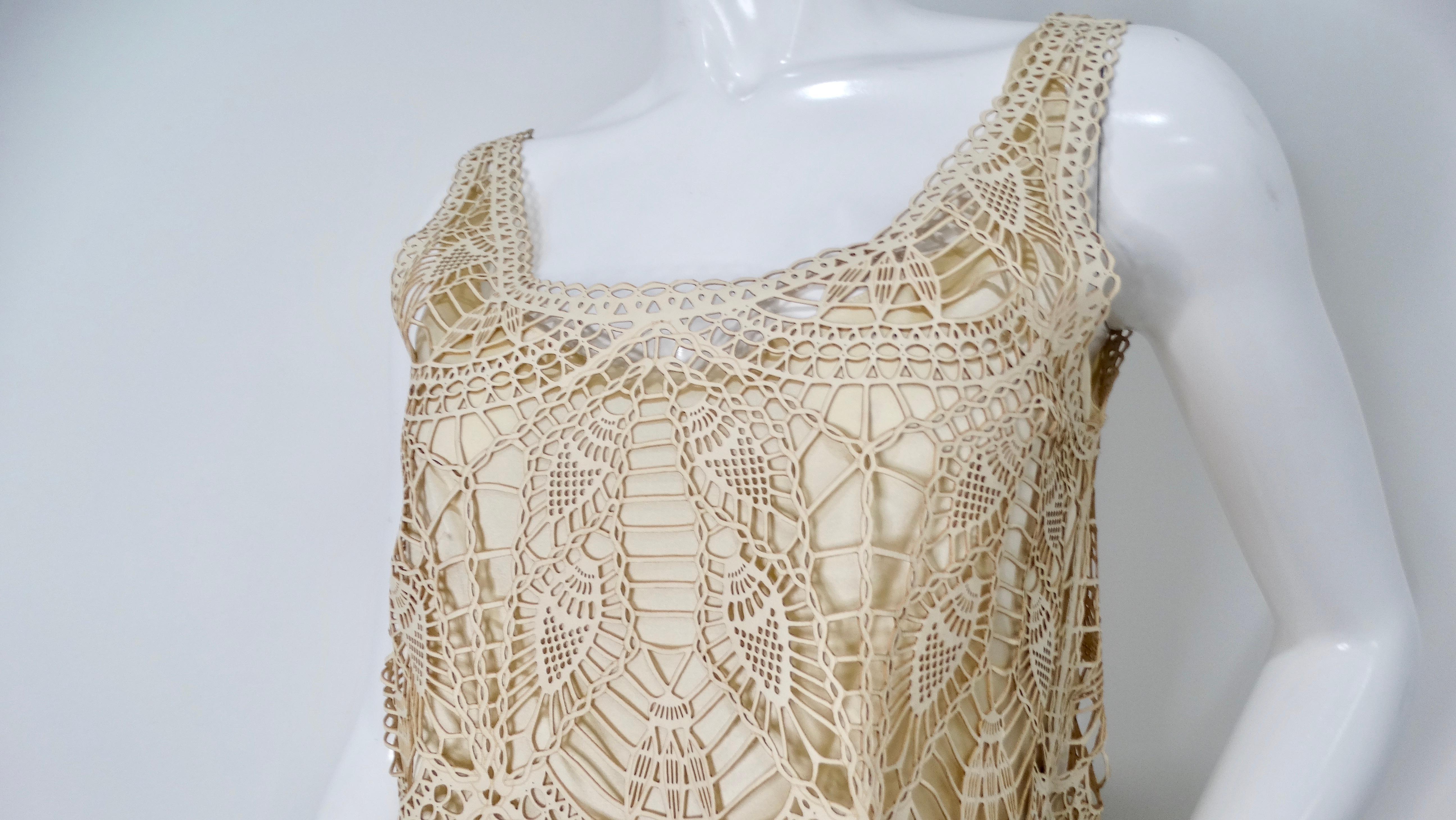 The 1990s leather crochet style top is a striking piece that embodies the bohemian aesthetic of the era. This unique outer layer features intricate crochet style detailing in supple leather, providing both texture and visual interest. Paired with a