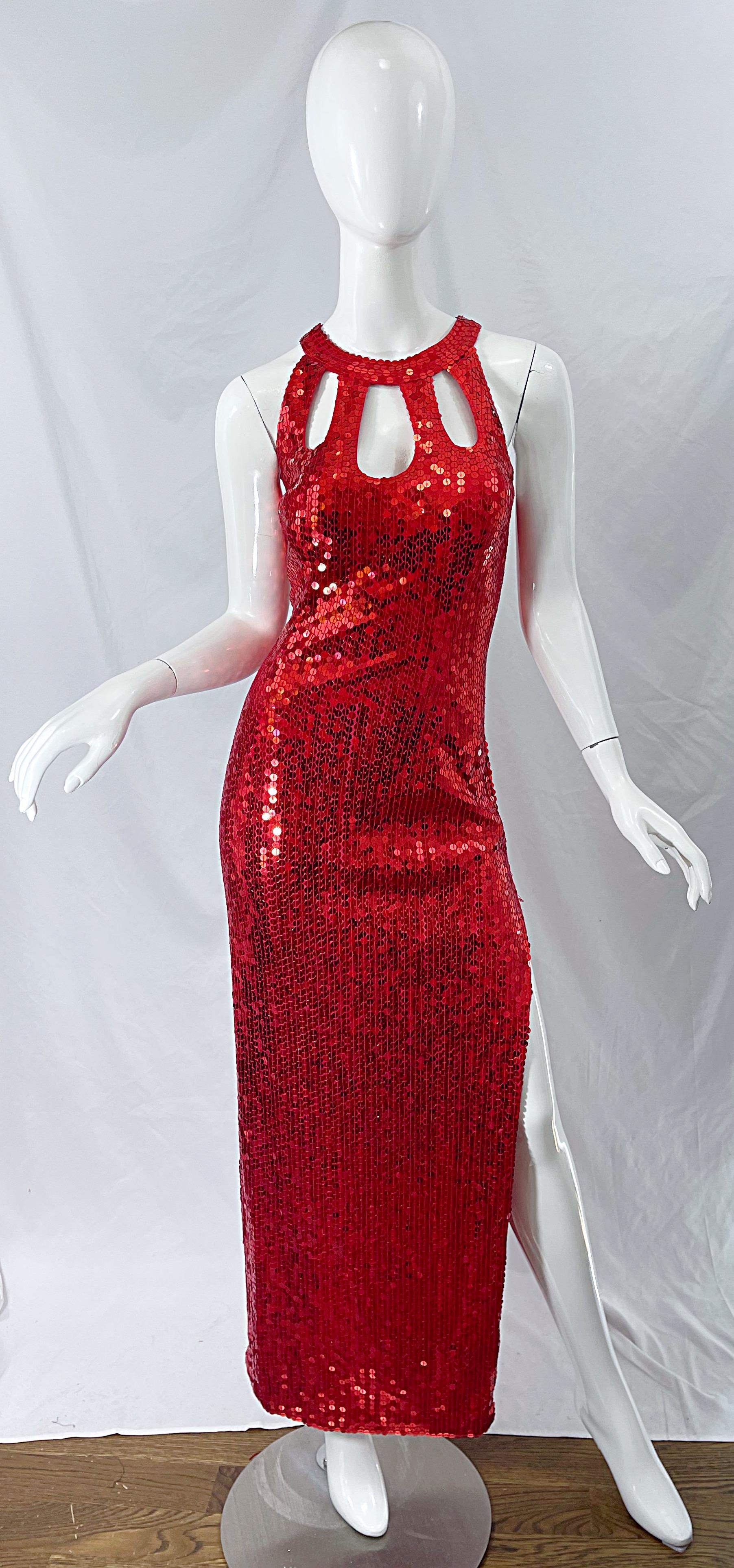 Sexy vintage 90s cut-out fully sequined lipstick red evening gown ! Features thousands of hand-sewn red sequins throughout. Cut-out details above the bust. Thigh high slit up the left leg. Hidden zipper up the back with hook-and-eye closure. 
In