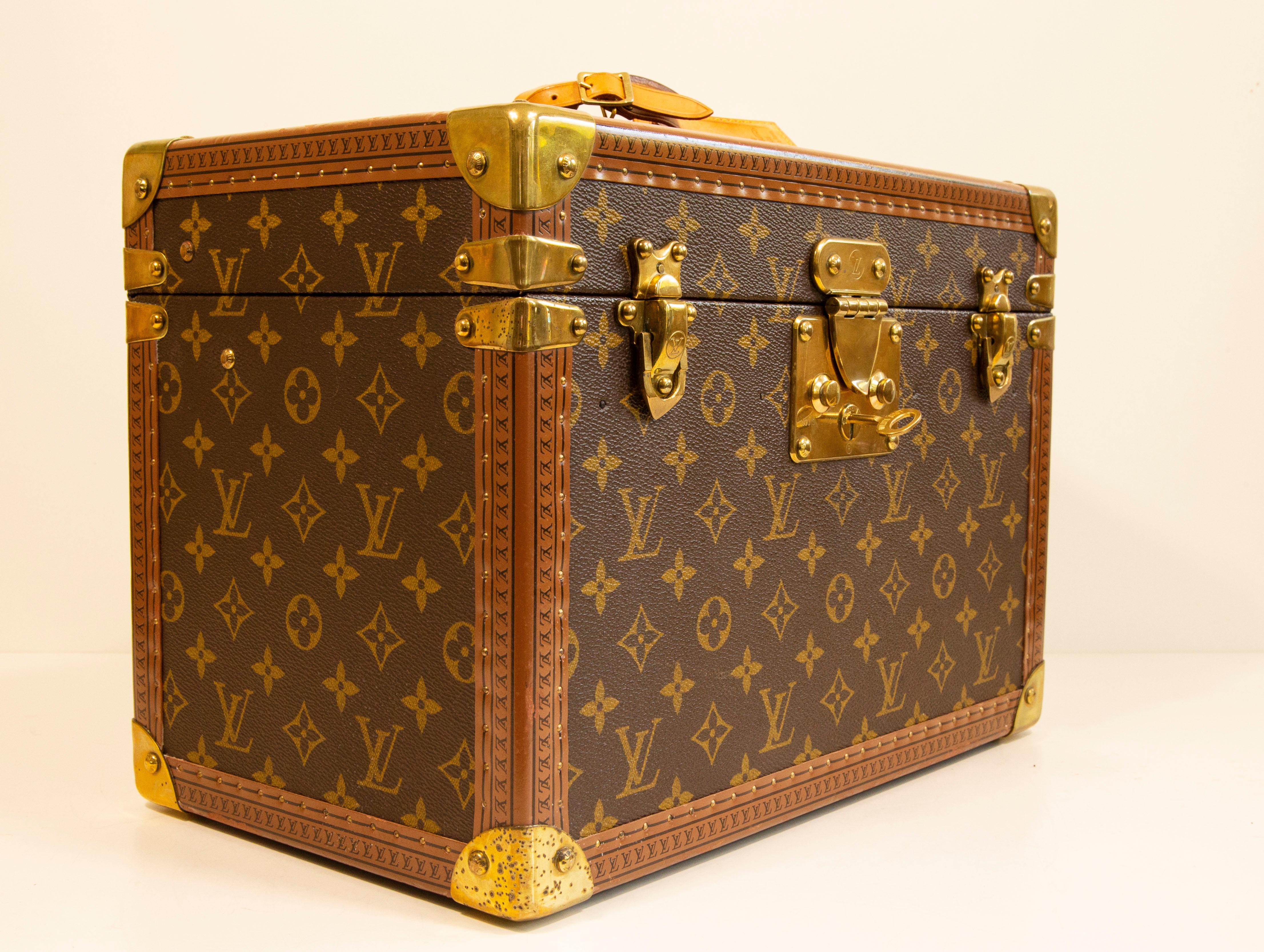 Louis Vuitton Monogram hard shell Boite Pharmacie Vanity Trunk Case. The item was manufactured in the late 1990'. It features brass hardware, push lock closure including the key, vachetta leather top handle, vachetta leather tag. The interior is