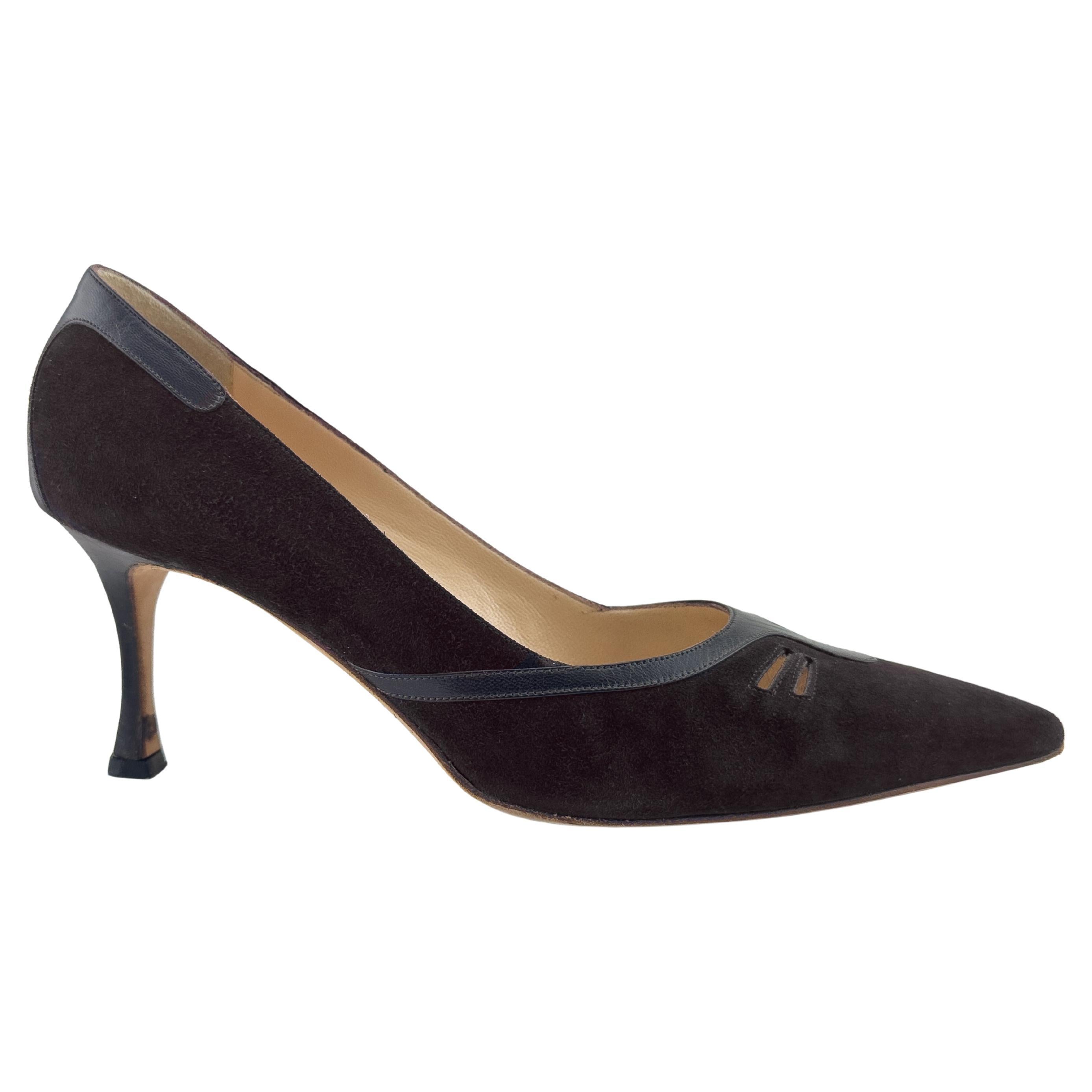 Very classic and timeless Manolo Blahnik pumps from the 1990s. Dark chocolate brown suede with black leather trim throughout and small horizontal cut outs at the toe box. Elongated pointy toe with a sensible and comfortable 2