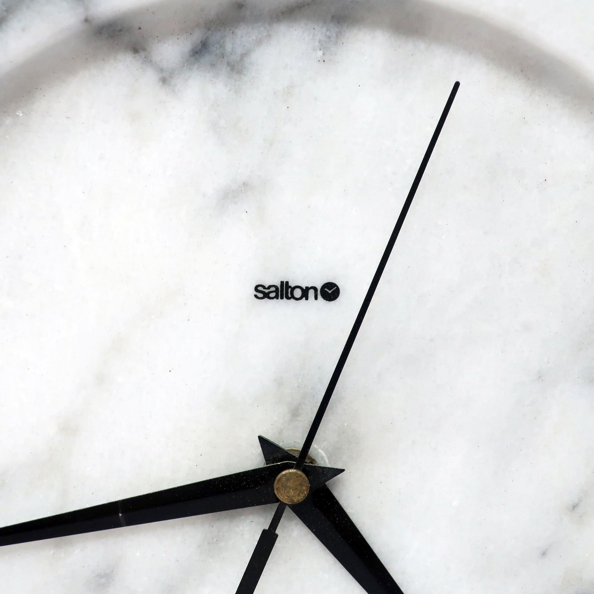 A very sophisticated white marble wall clock with light gray figuring by Salton.  The manufacturer's name is on the clock's face just below the 12 o'clock position.  In very good vintage condition and works great.

10