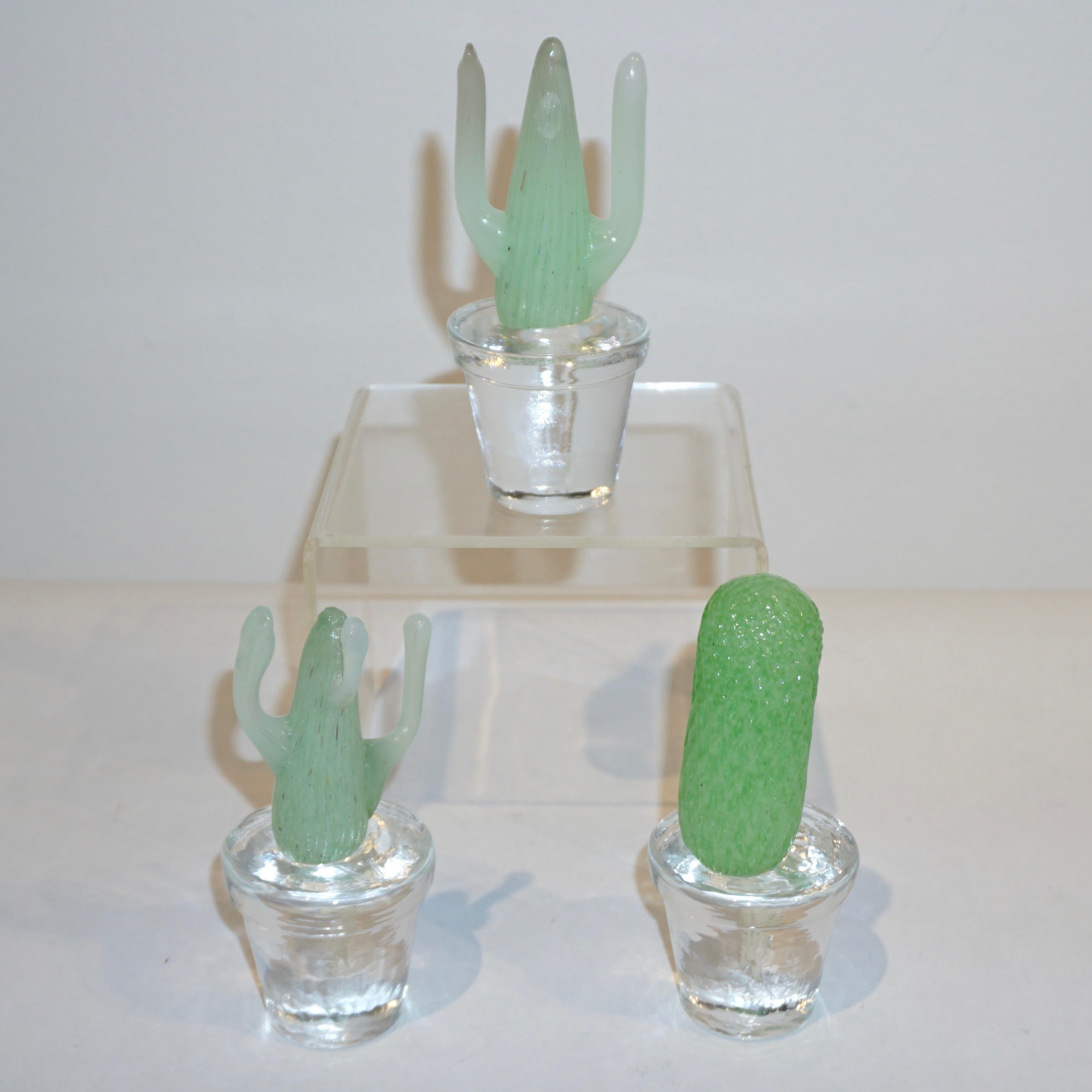 Italian minimalist collectible miniature plants of limited edition, Modern Design by Marta Marzotto, realized by Formia, 3 different lifelike organic shapes in verdant emerald green and light pea green color, planted in crystal clear Murano Glass