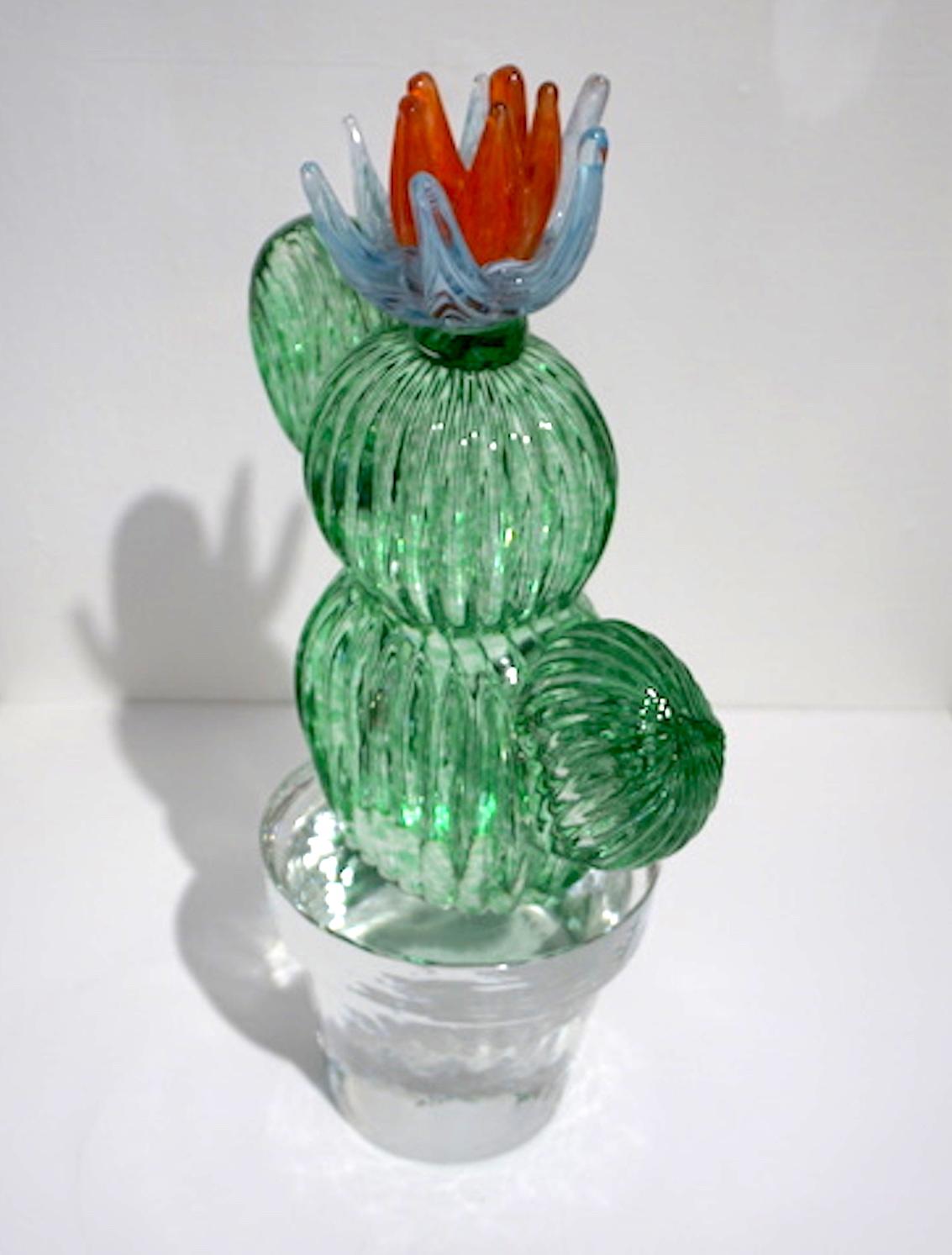 1990s Italian highly collectible cactus of limited edition, Modern Minimalist Design by Marta Marzotto, blown by Formia, in a lifelike organic shape in verdant light emerald green Murano glass with double corolla flower in light blue striated with