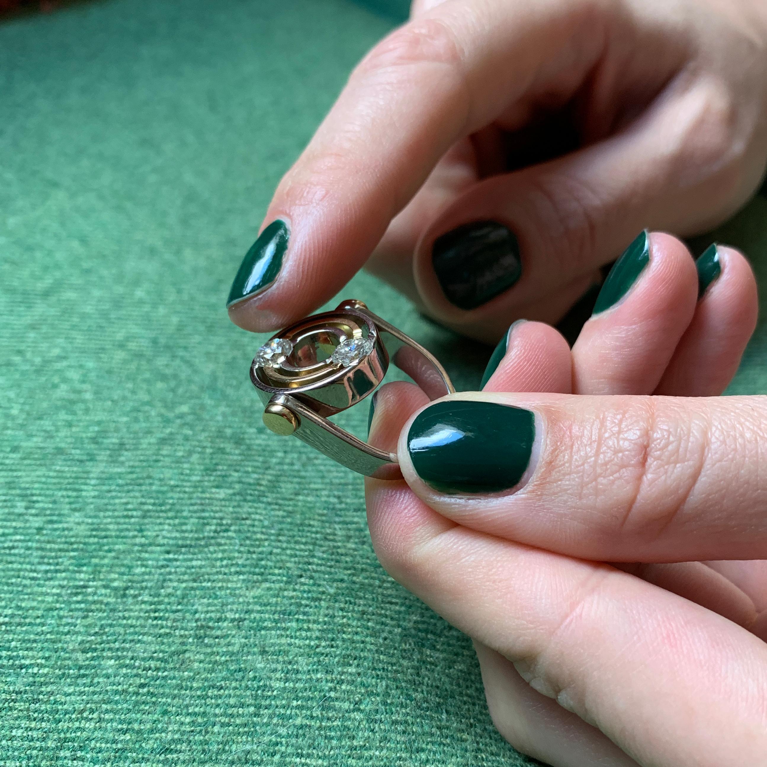 A fine diamond and 18 karat white and yellow gold kinetic ring, by Swedish goldsmith Mats Eskils, 1993. The ring is a size 5.25 and measures 0.6