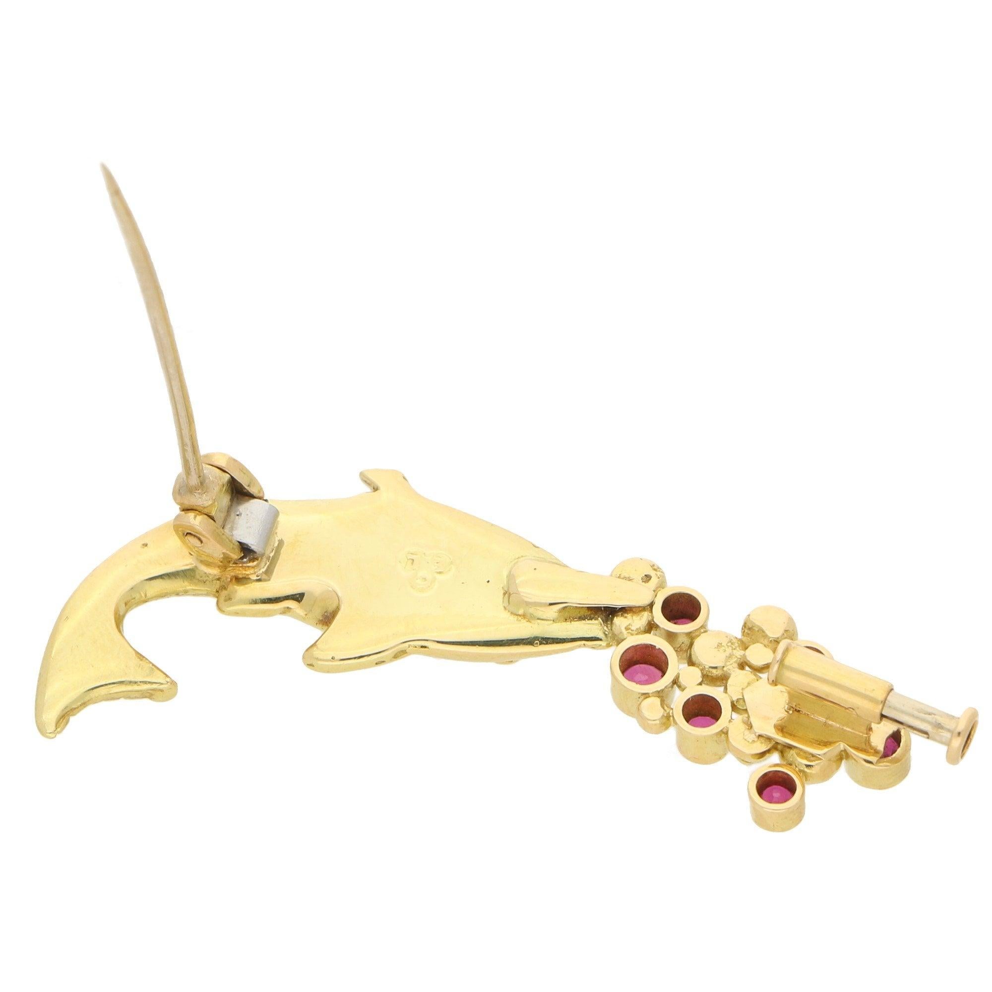 An extremely charming Mecan Elde ruby and diamond fish brooch set in 18k yellow gold, circa 1990. 

This quirky piece depicts a swimming fish and has been carefully hand carved to show naturalistic features such as scales and fins. The fish is