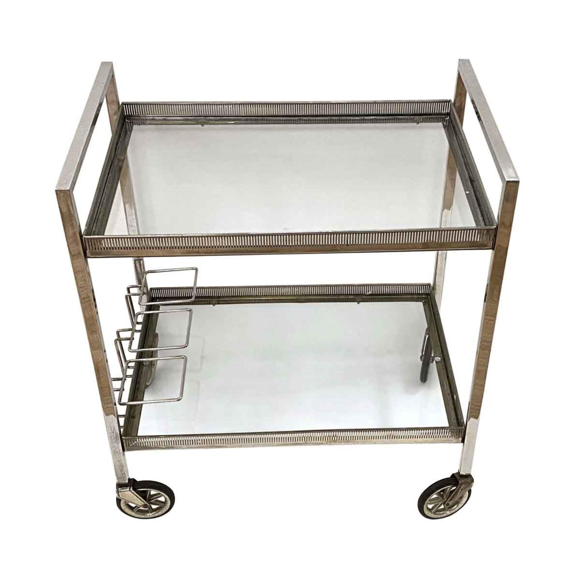 1990s Belgium Mid-Century Modern bar cart made of nickel over brass with glass shelves. This can be seen at our 333 West 52nd St location in the Theater District West of Manhattan.