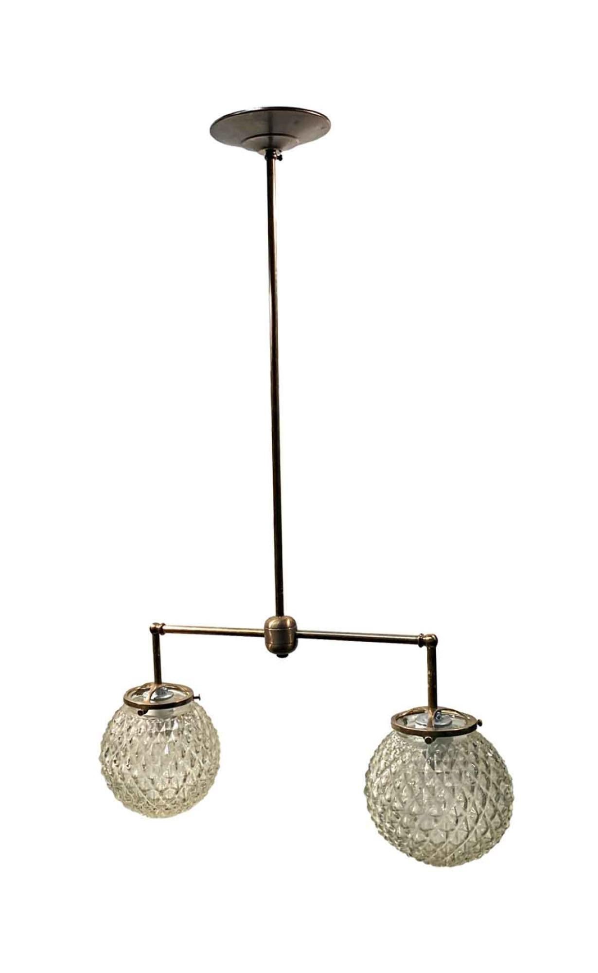 Mid-Century Modern textured cast glass 6 inch diameter globes from the 1990s configured on a new double socket brass pole fitter. Fitter available in either brass, nickel or brushed steel. Price includes restoration.