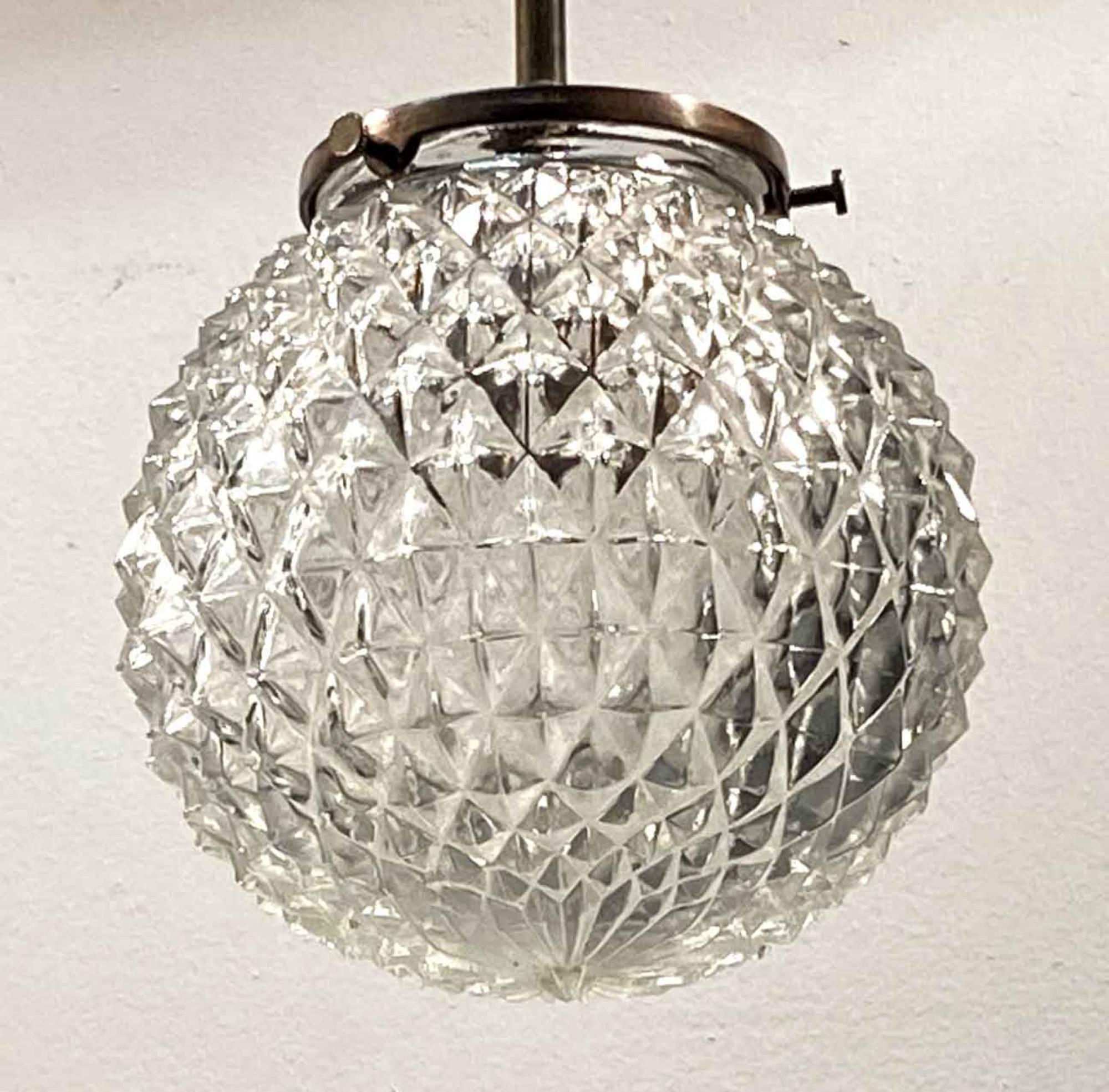 1990s Mid-Century Modern style textured cast glass globe configured on a new brass pole fitter. This can be seen at our 400 Gilligan St location in Scranton. PA.