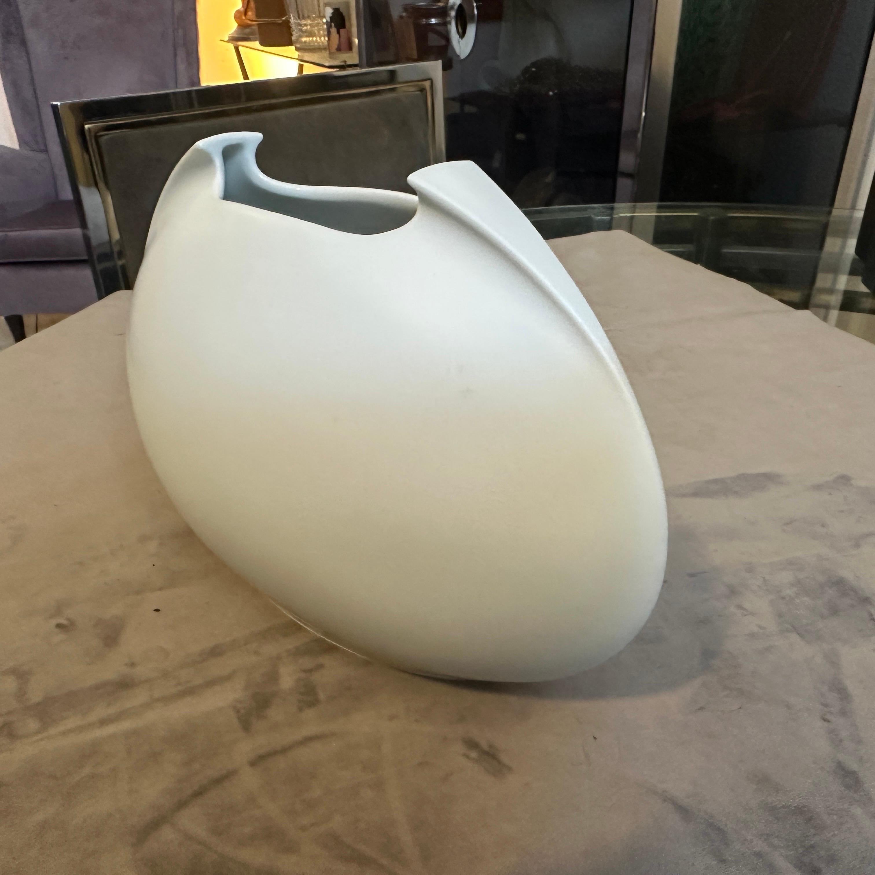 A sophisticated and striking Minimalist White Porcelain Tasca Vase designed by the celebrated Italian designer Lino Sabattini for Rosenthal Studio-Linie, Germany. This sculptural piece, originally designed in 1986 and produced in the 1980s or 1990s,
