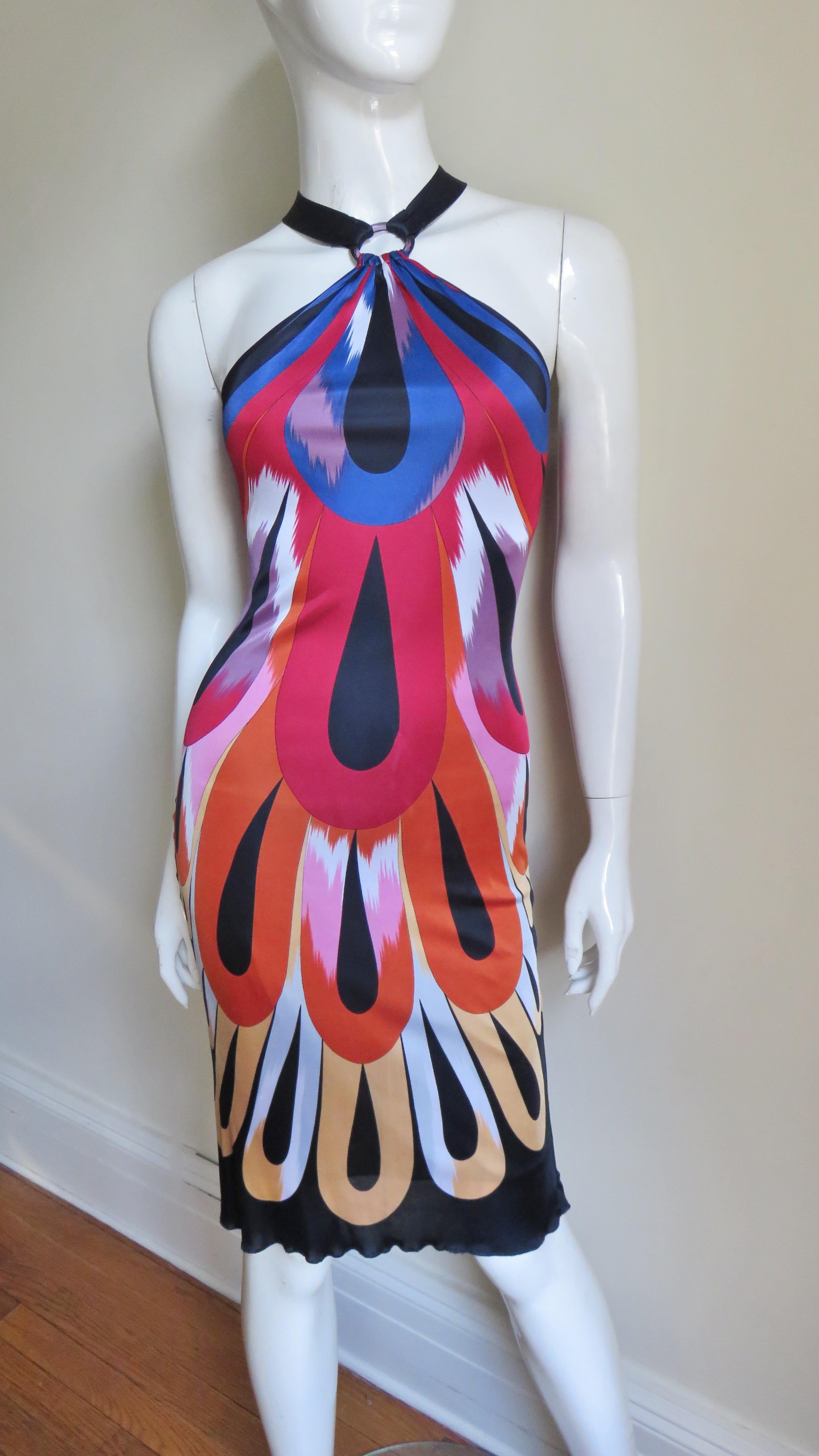 A fabulous colorful silk knit halter dress from Missoni. The pattern is abstract in red, orange, blue, yellow, white, lavender and black. The dress slips on over the head with 2 black straps which snap closed at the back of the neck around a clear