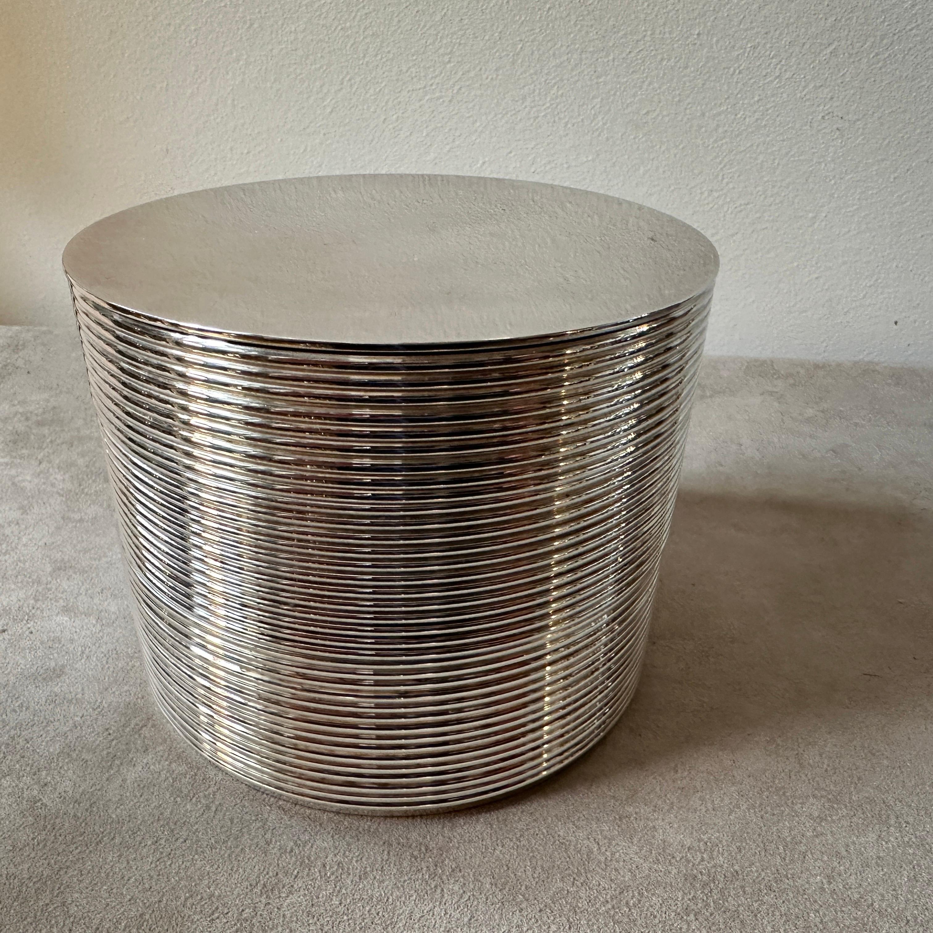 A stylish three-level round silver-plated box, designed by KT Studio for Christofle in 1998 with input from Thomas Keller and Adam Tihany, is a remarkable piece of modernist craftsmanship. When closed, it's a modernist cylinder; when opened, it
