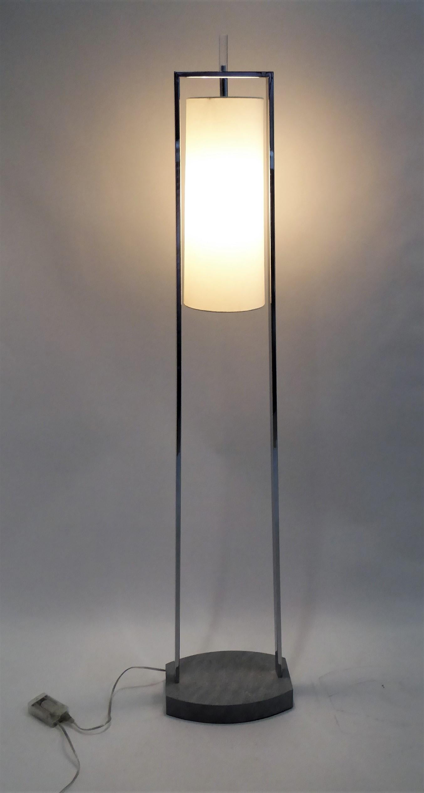 In the Minimalist manner of Paul Mayen, a pair of modern chrome standing floor lamps by Van Teal of Miami. Two 70 inch chrome posts rise from a faux green gray marbleized weighted metal base. A horizontal trestle supports the oversized cylindrical