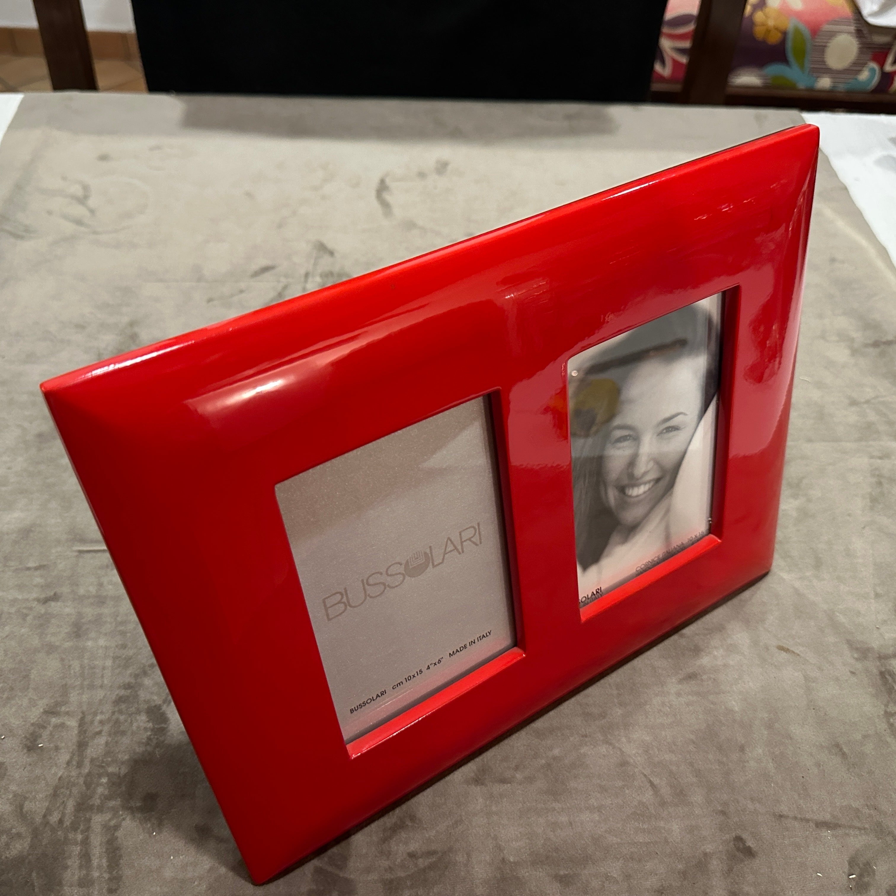 1990s Modern Red Lacquered Wood Italian Design Double Picture Frame by Bussolari.
Add a bold pop of color and sleek Italian design to your décor with this striking double picture frame by Bussolari, crafted in Italy during the 1990s. Made from