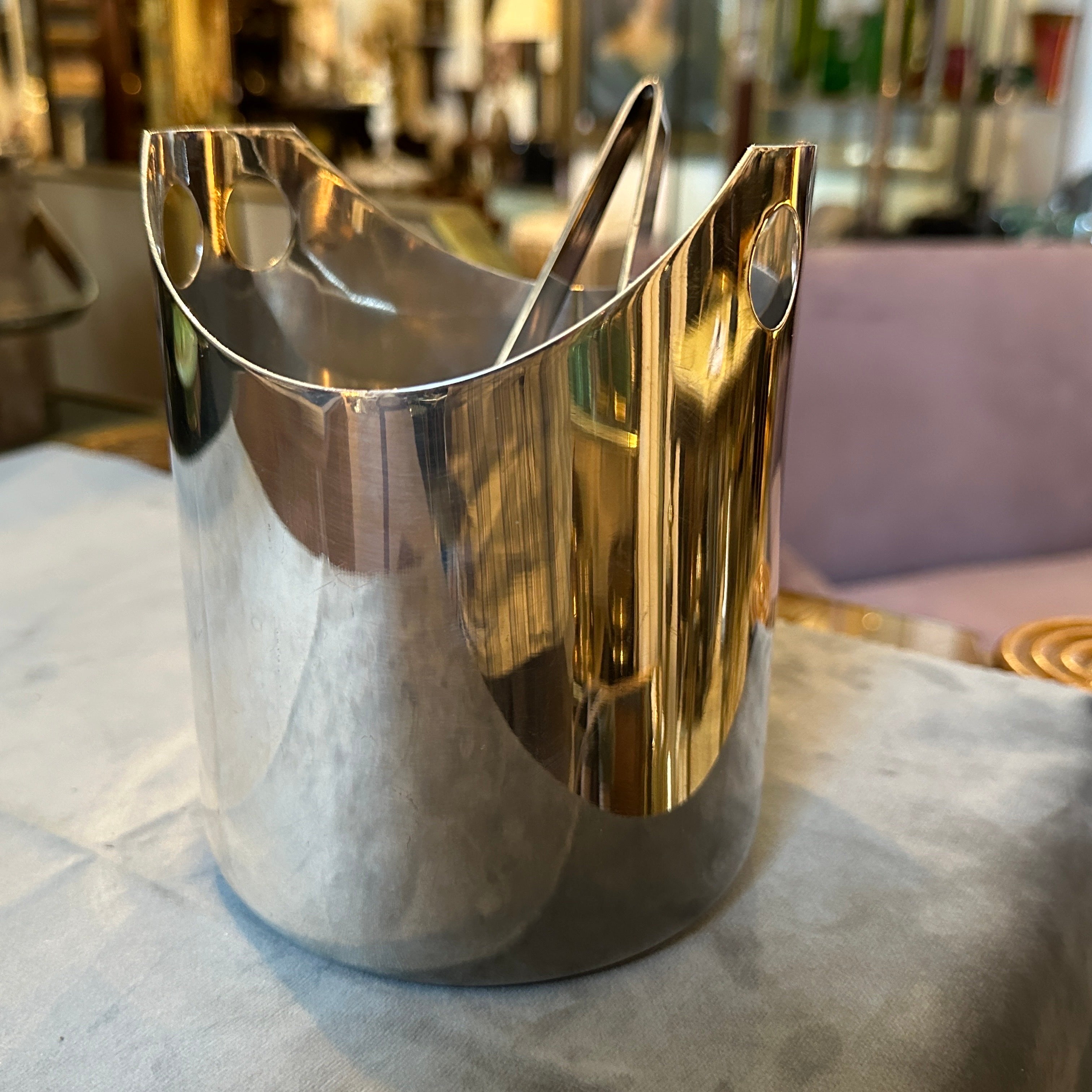 A silver plated ice bucket designed by Lino Sabattini and manufactured in Italy by Sabattini Argenteria, the tongs is designed by Sabattini and manufactured by Christofle. The two iconic design pieces are in perfect conditions, ice bucket probably