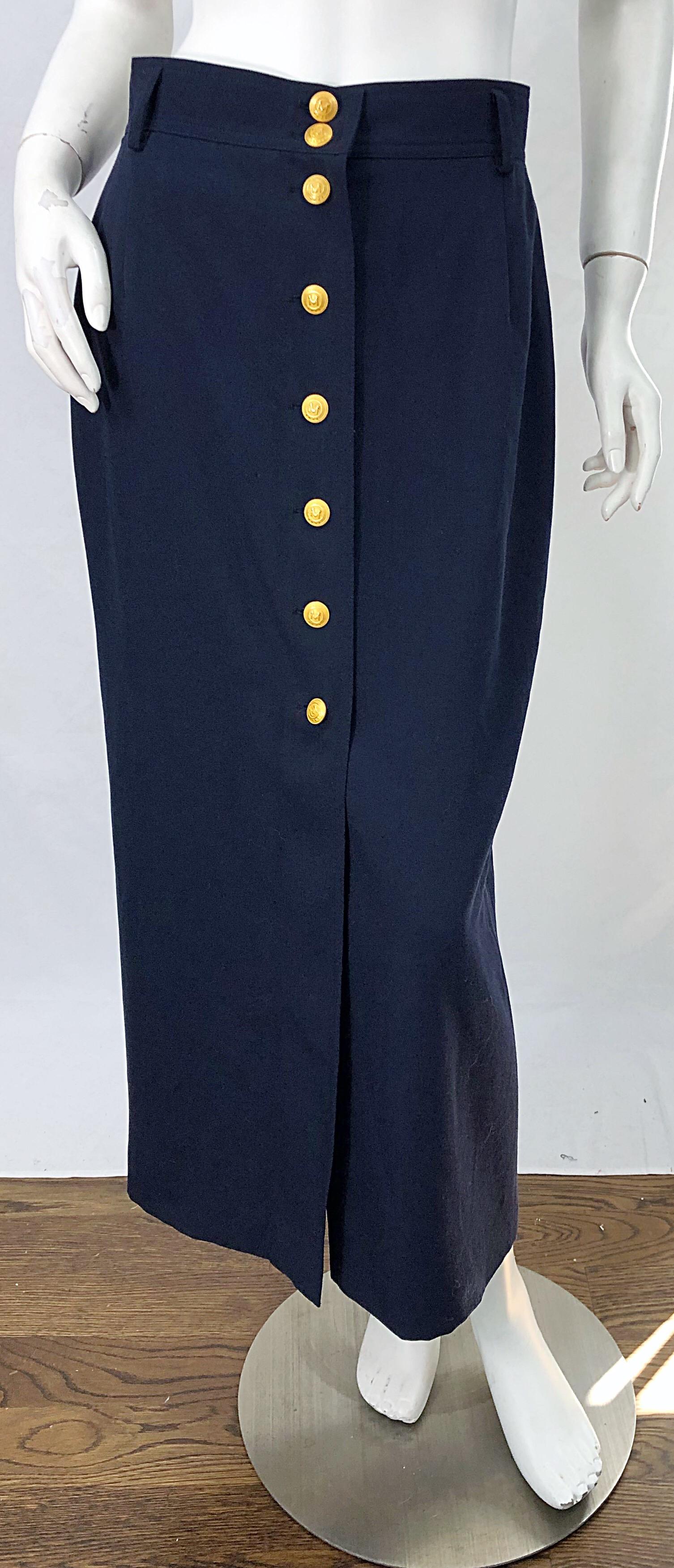 Chic 1990s MONDI navy blue midi skirt ! Features a lightweight wool blend. Gold logo embossed buttons up the front. Fully lined. Can easily be dressed up or down. The perfect midi length can go from day to evening. 
In great condition
Made in