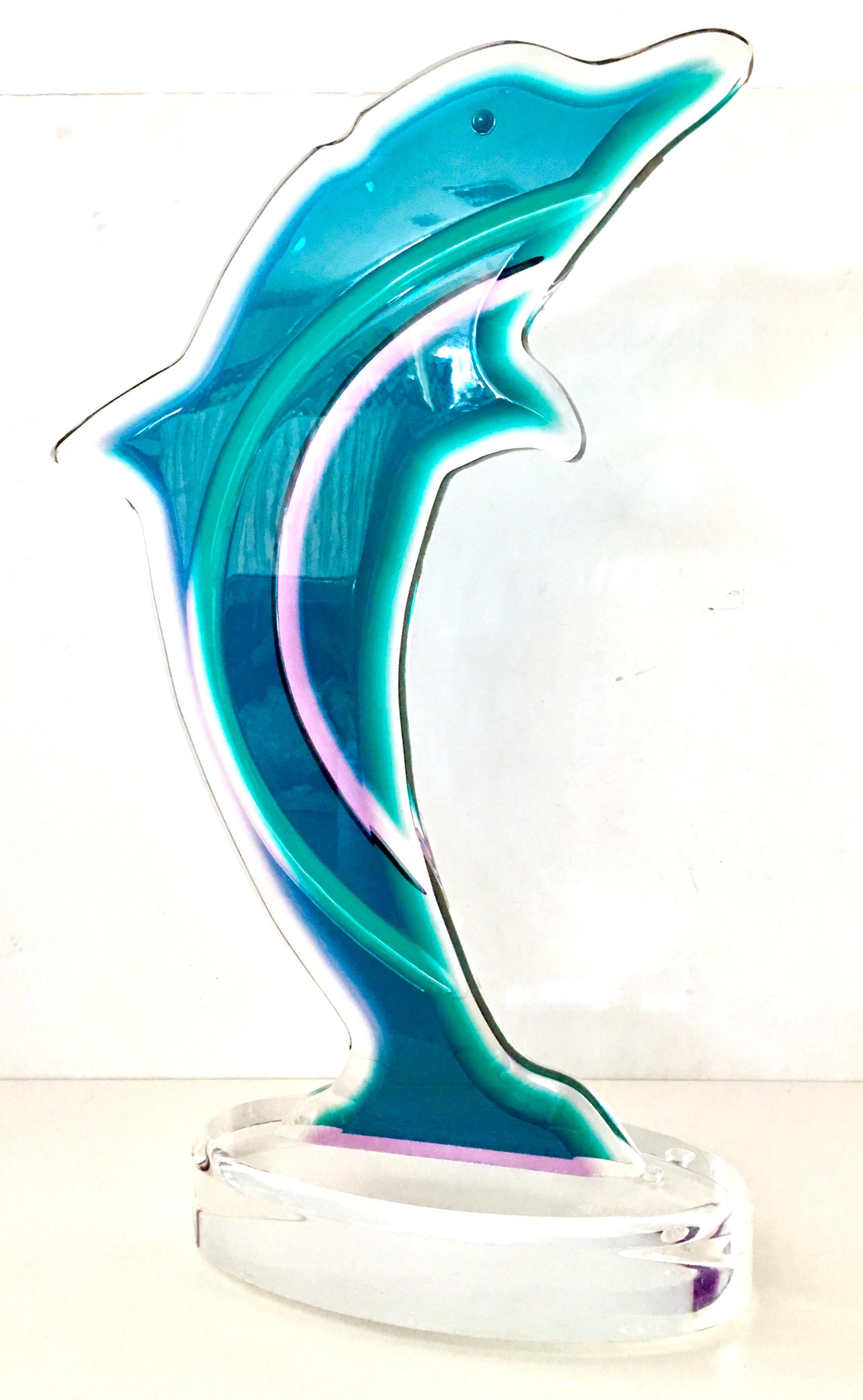 1999 monumental carved Lucite dolphin sculpture by, Muniz. Executed in teal, purple and transparent with great attention to detail. Signed on the transparent base, Muniz 99.
Muniz is a family owned business, located in Miami Florida and fabricates