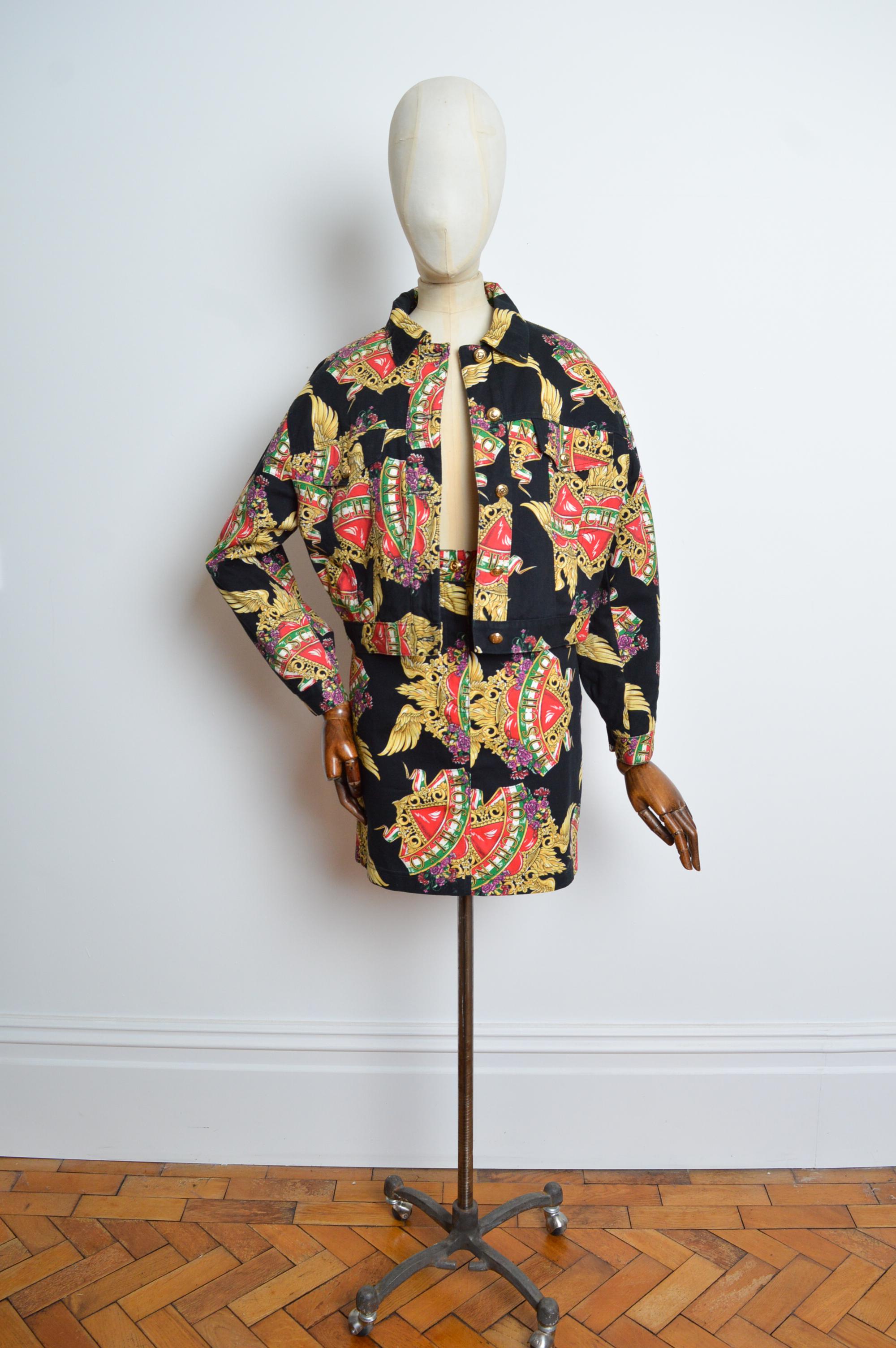 1990's MOSCHINO Baroque Italian Heart Denim Jacket & Mini Skirt Set
A Flamboyantly chic 1990's example of Franco Moschino. Comprising a quilt-lined denim jacket with matching high-waisted mini skirt. 
Features; Jacket - Central line button fasten,