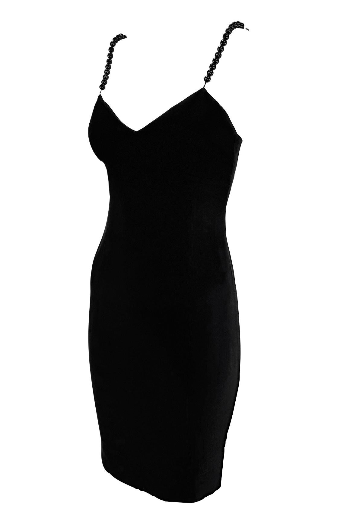 This Moschino Cheap & Chic slip dress from the 1990s features a sleek black silhouette. The minimalist design is elevated by playful black bauble-beaded shoulder straps.

Approximate measurements:
Size - IT42, D38, F38, GB10, US8
Bust: 28