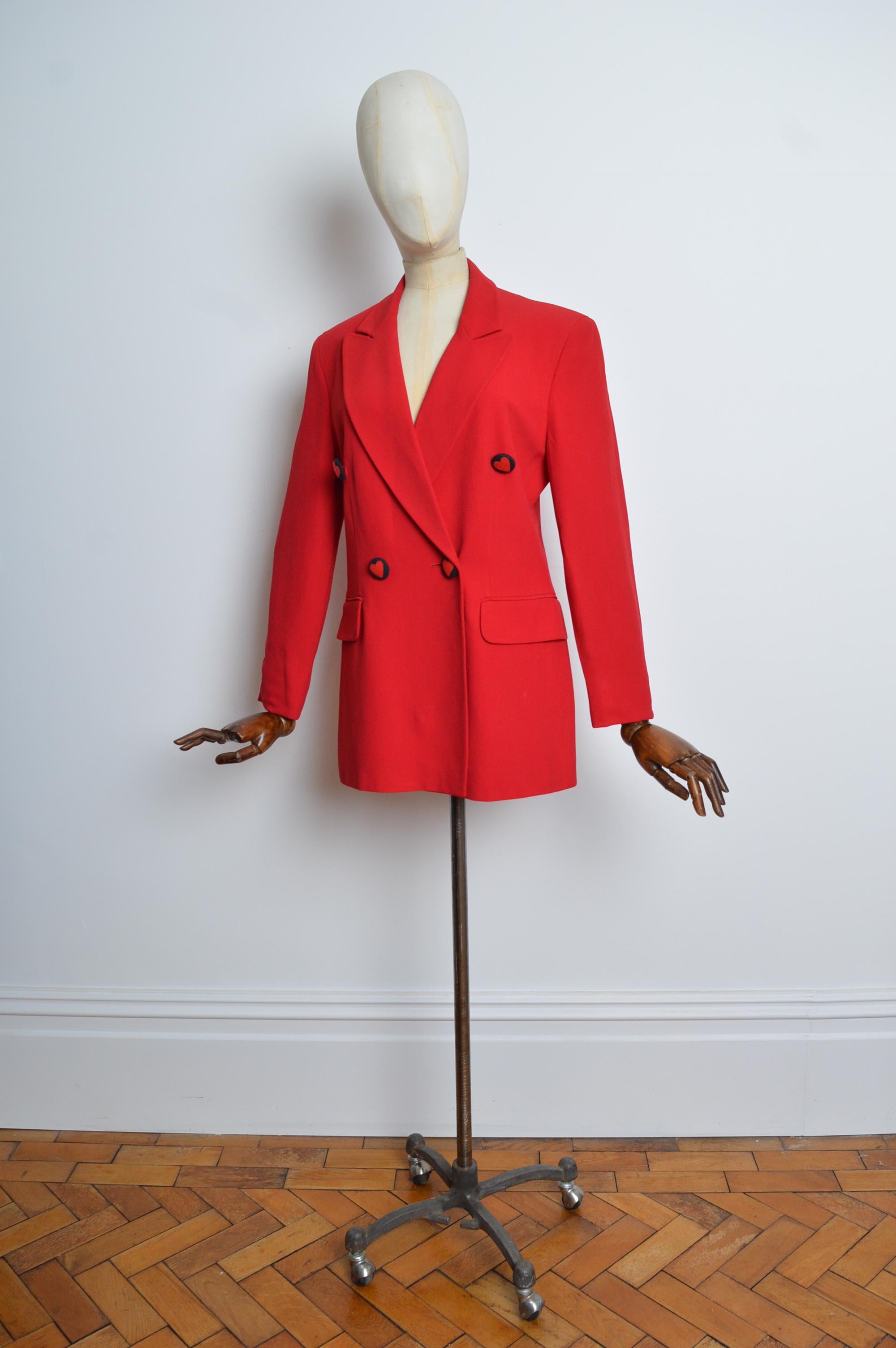 Fabulous 1990's MOSCHINO 'Cheap & Chic' Plain Red Double Breasted Blazer - Jacket
Features; Heart detailed buttons on the front, pockets at the hips, 3/4 bracelet length sleeves, square shoulders and a loose tailored silhouette. 
MADE IN ITALY
Size;