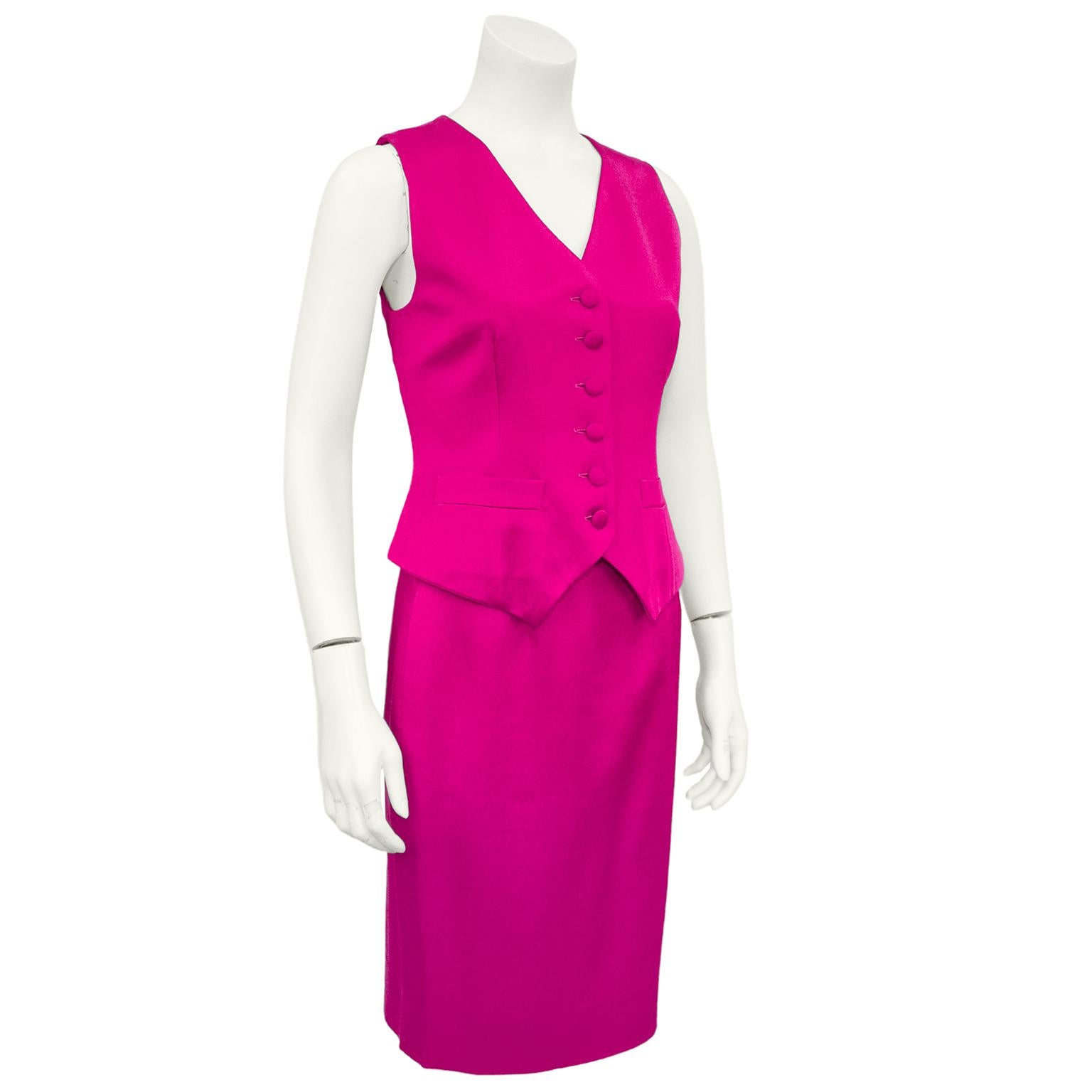 Fun and vibrant Moschino Couture! bright fuchsia ensemble from the 1990s. Ensemble features vest with v neckline, covered buttons and horizontal slit pockets. Skirt is a classic highwaisted pencil skirt with a zipper & button closure on the left