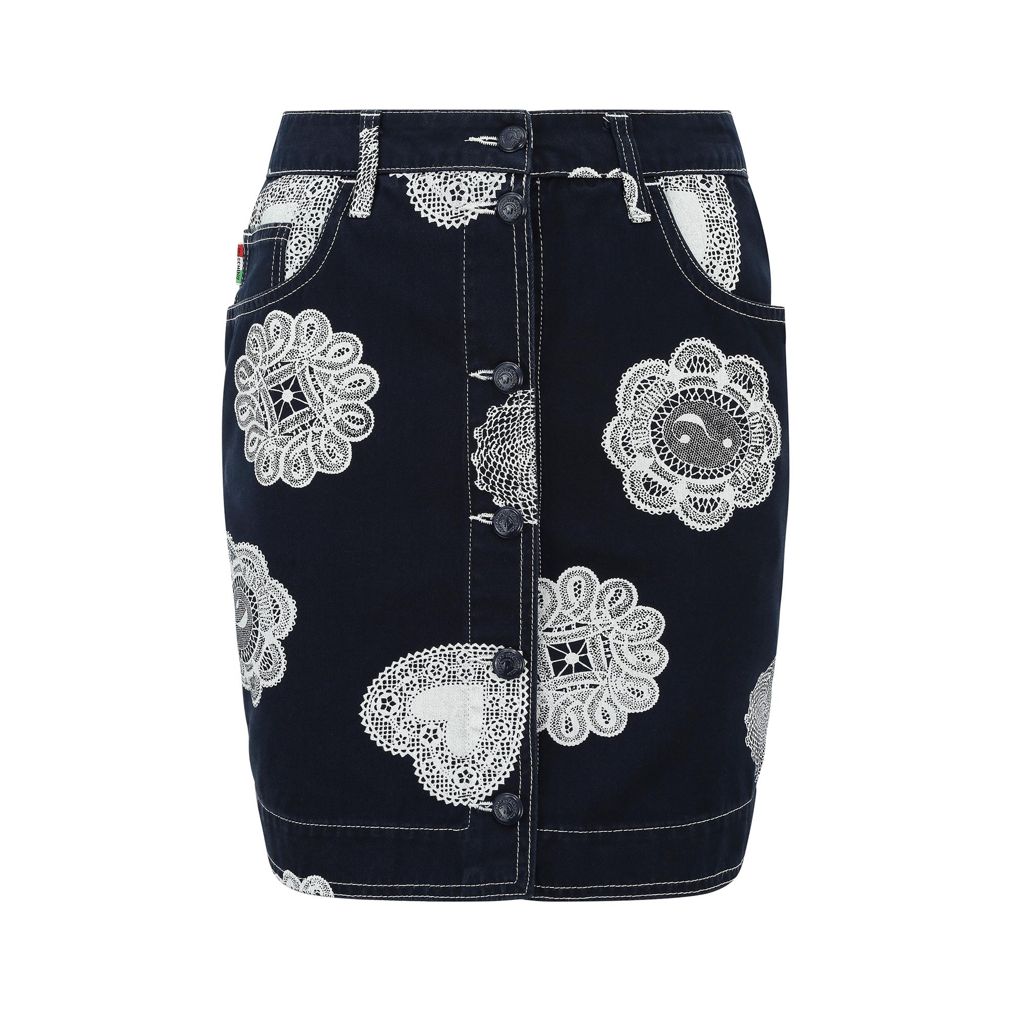 This early 1990s Moschino Jeans novelty denim mini skirt is constructed from a medium to light weight deep indigo wash denim, with a super fun, white doily print.  It has some whimsical  brand markings embedded in the design such as the ? mark and a