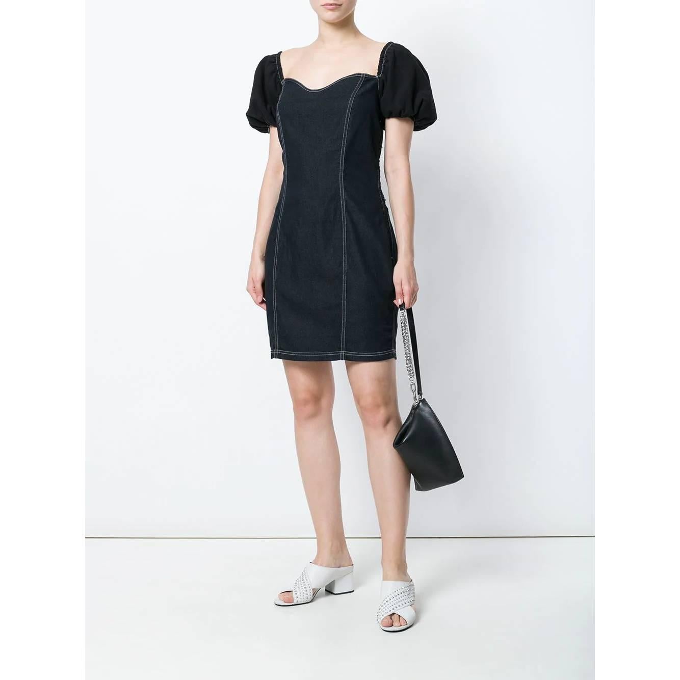 Moschino black cotton blend denim dress with white decorative stitching. Sweetheart neckline, short balloon sleeves and side zip closure. Wide neckline on the back with corset style laces.

Years: 90s

Made in Italy

Size: 44 IT

Flat