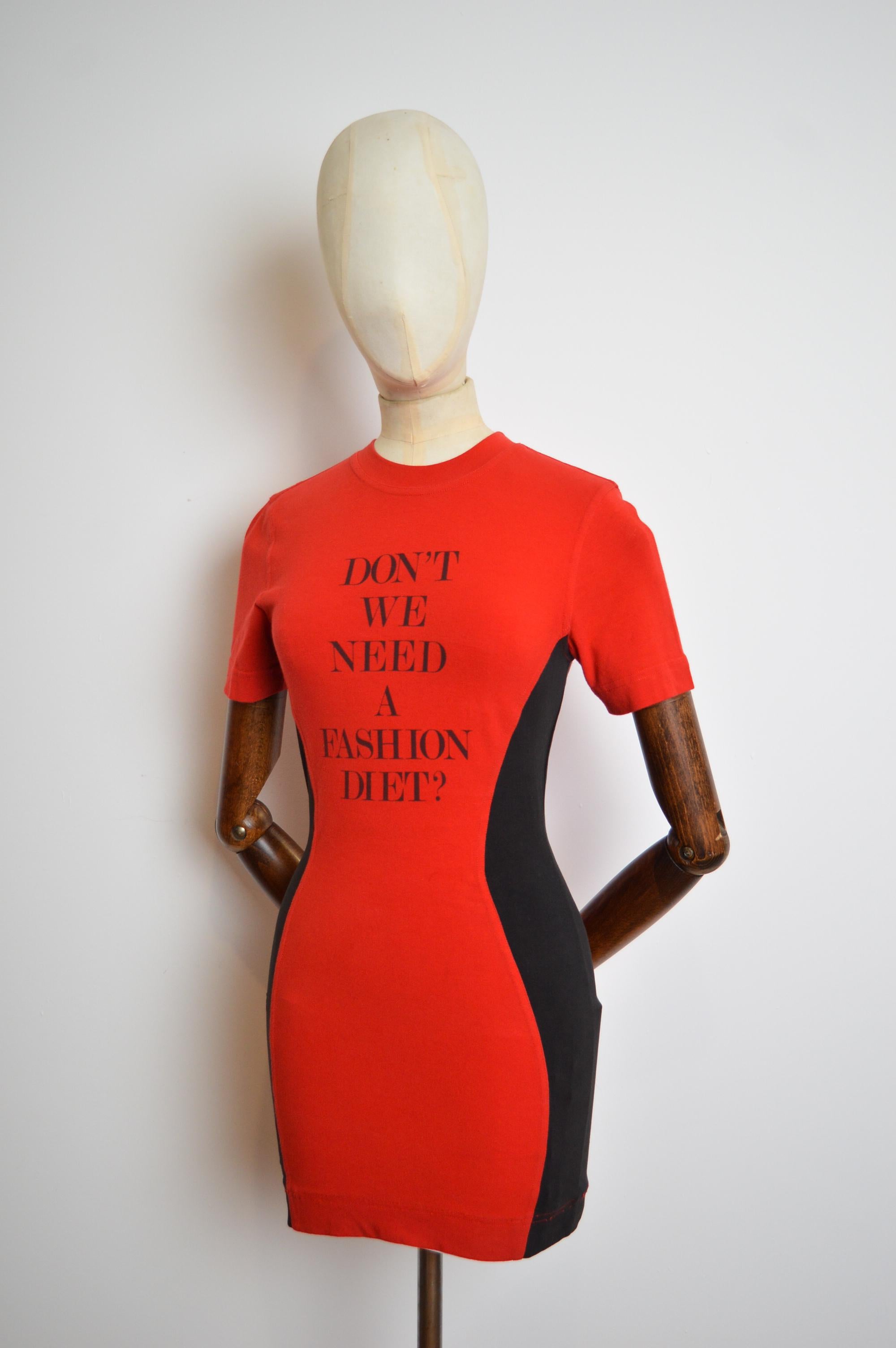 1990's MOSCHINO 'Don’t we need a Fashion Diet ?' Slogan Body con mini dress made from stretchy red & black cotton. 
MADE IN ITALY.
Stretchy fit 
Pit to Pit; 16-18”
Nape to Hem; 30”
Recommended Size; UK 8-10
Waist; 27-32”
Condition; 7/10 a couple of
