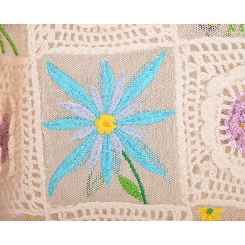 Vintage 1990's Moschino 'CHEAP & CHIC' button down cardigan with intricate floral embroideries on mesh patch-worked panels and crochet squares. 

Features:
Cropped Fit
Buttons down front
Crochet
Long sleeves

Sizing given in inches:

Pit to Pit;