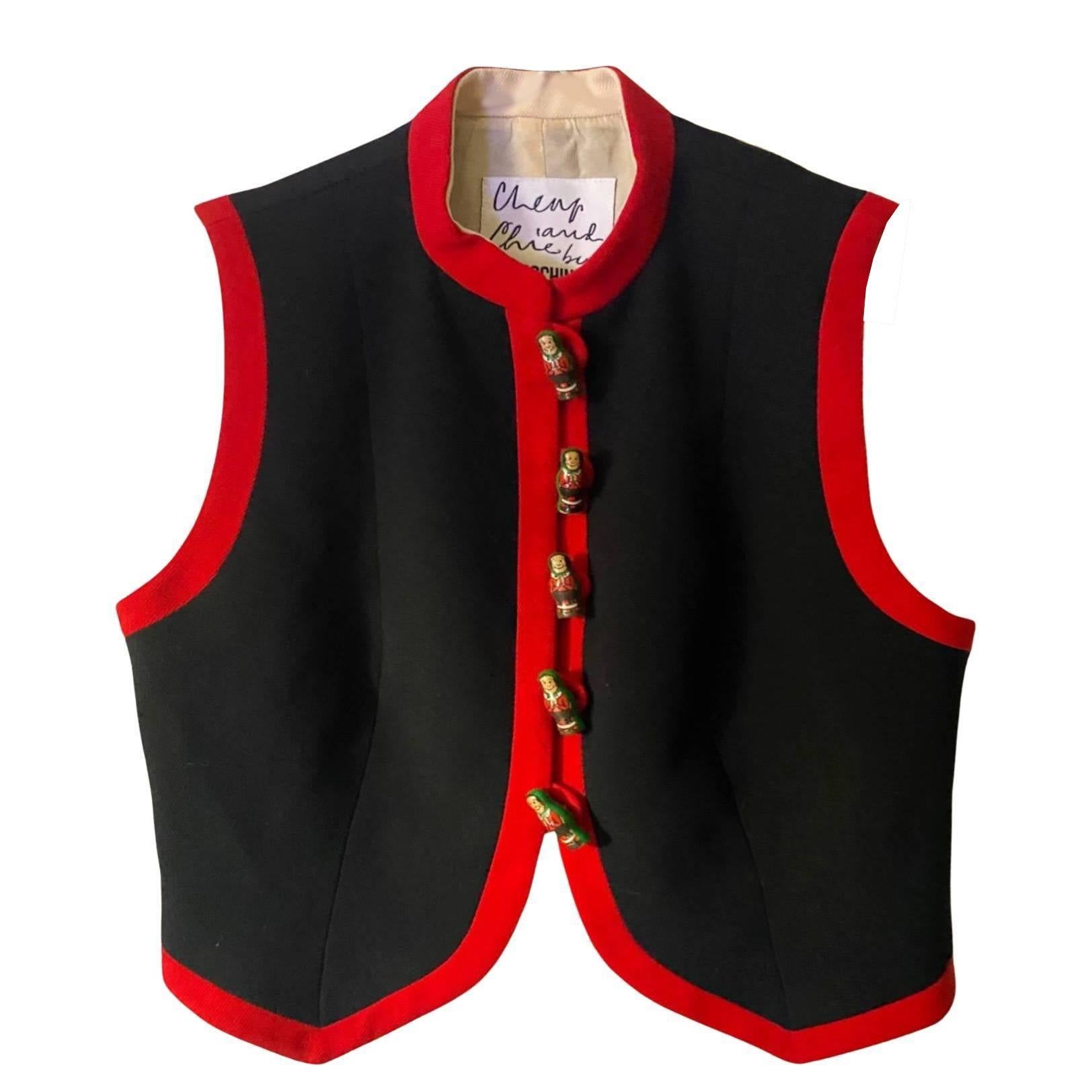 1990s Moschino Waistcoat in black, with a red trim and a wooden Russian doll Matryoshka button front fastening, fully lined and made from 100% Wool A unique garment crafted from 100% wool, this waistcoat shows off precision design and craftsmanship