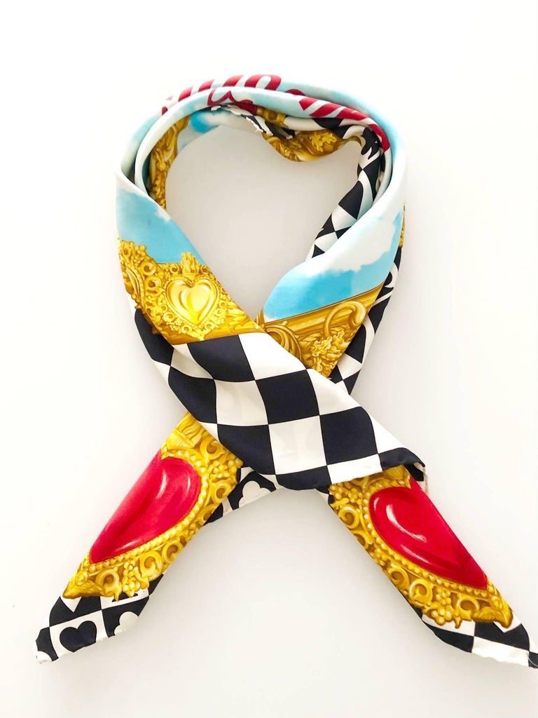 Absolutely stunning vintage Moschino pure silk large square scarf featuring
love hearts adorn the corners, with 'Moschino Forever' against a cloudy blue sky, in a gold frame in the middle, black and white playing card clubs, hearts, spades &