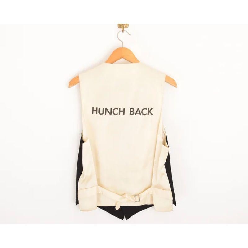 Vintage 1990's Moschino 'Hunchback' logo waist coat crafted from a Black Virgin wool with a satin feel fully adjustable back. 

MADE IN ITALY

Features:
Cheap & Chic Label
Virgin Wool
'HUNCHBACK' Logo to the reverse

Sizing given in inches : 
Pit to
