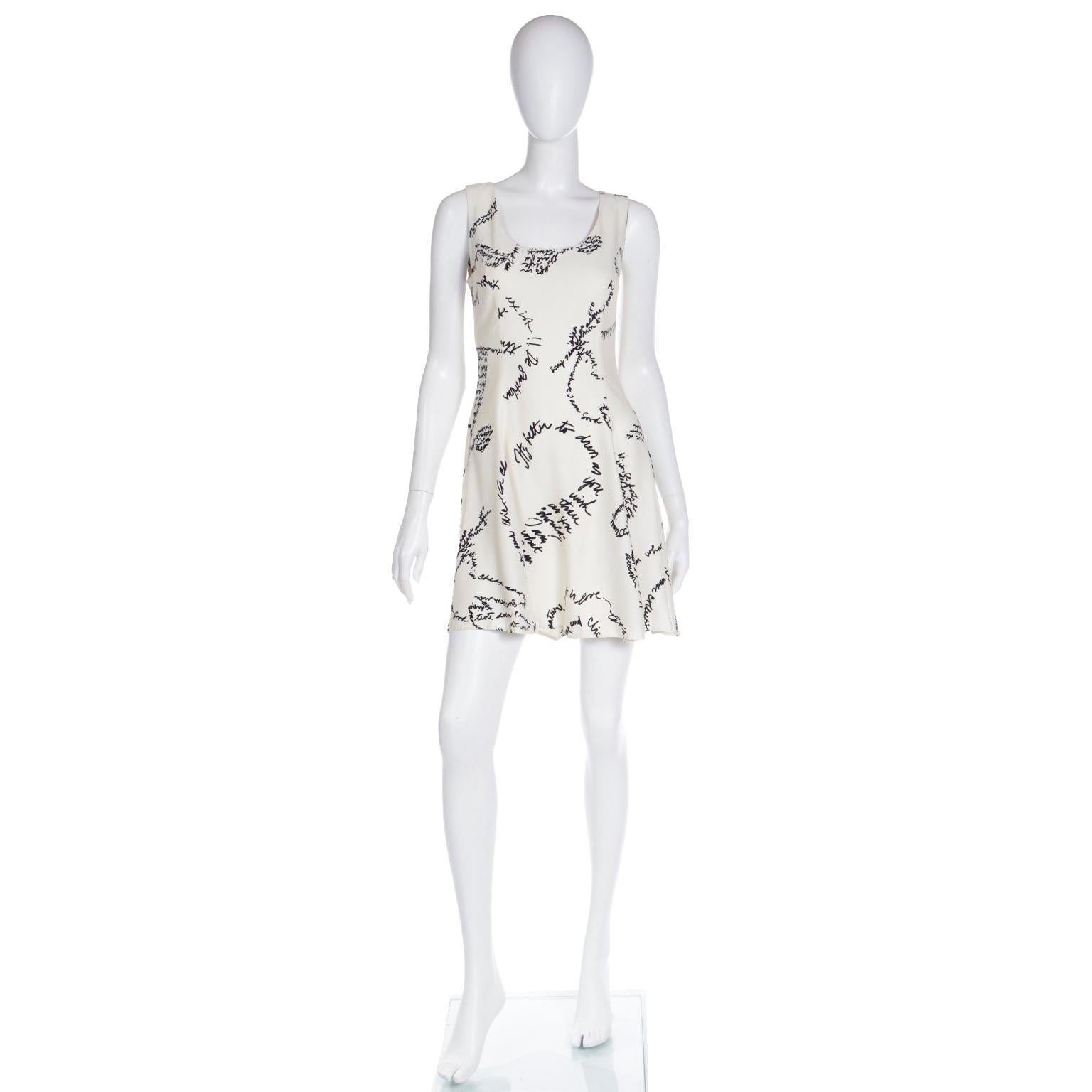 This is a fun vintage Moschino ivory - almost cream rayon dress covered in a black handwriting print with words about fashion including 
