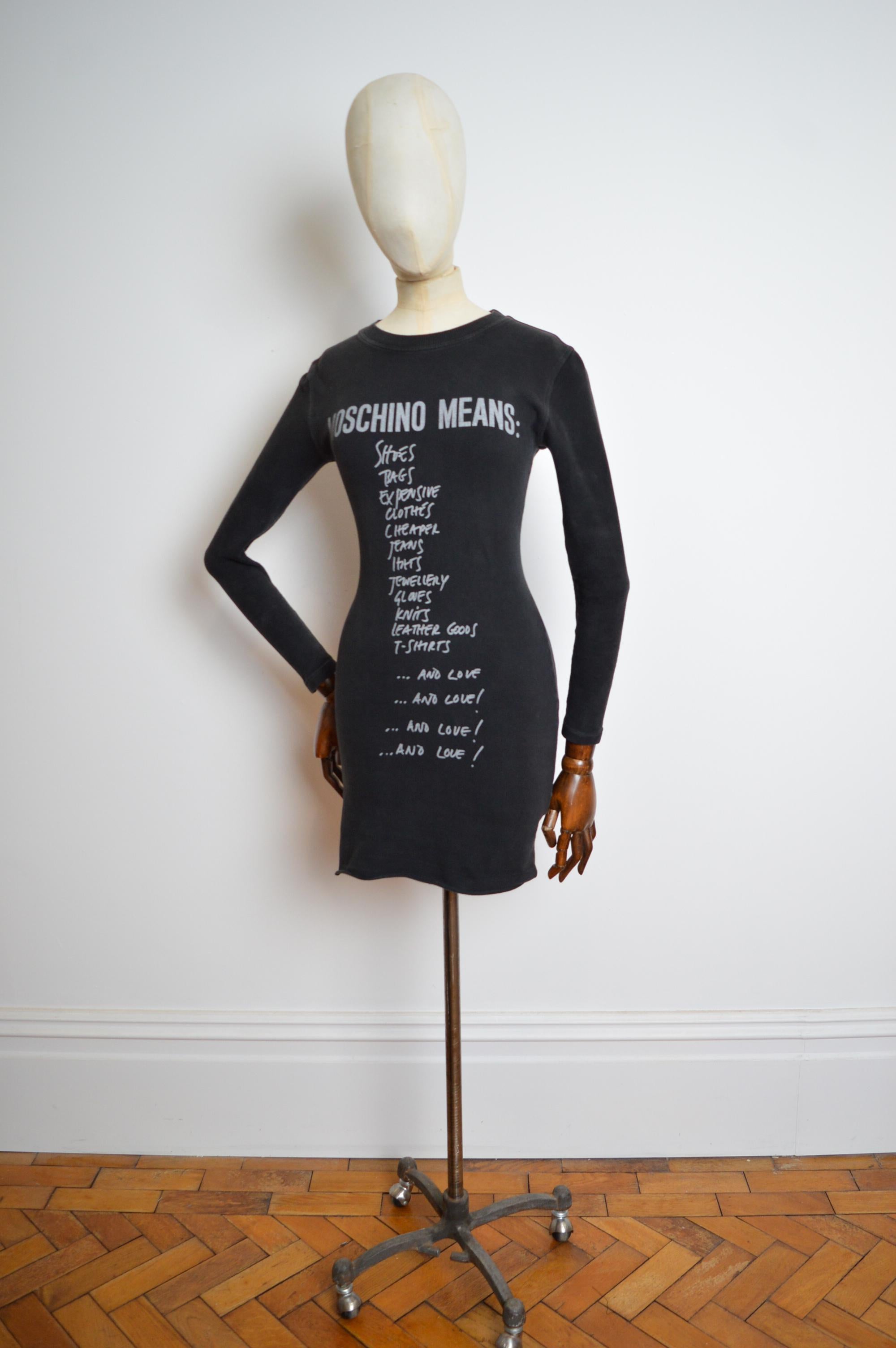 Early 1990's Moschino 'Tick List' Graphic slogan Little black mini Dress made from Thick stretchy sweatshirt Material featuring long sleeves.
MADE IN ITALY. 
88% Cotton 12% Elasthane
Pit to Pit; 17”
Pit to Cuff; 17”
Nape to Hem; 32”
Size; U.K.