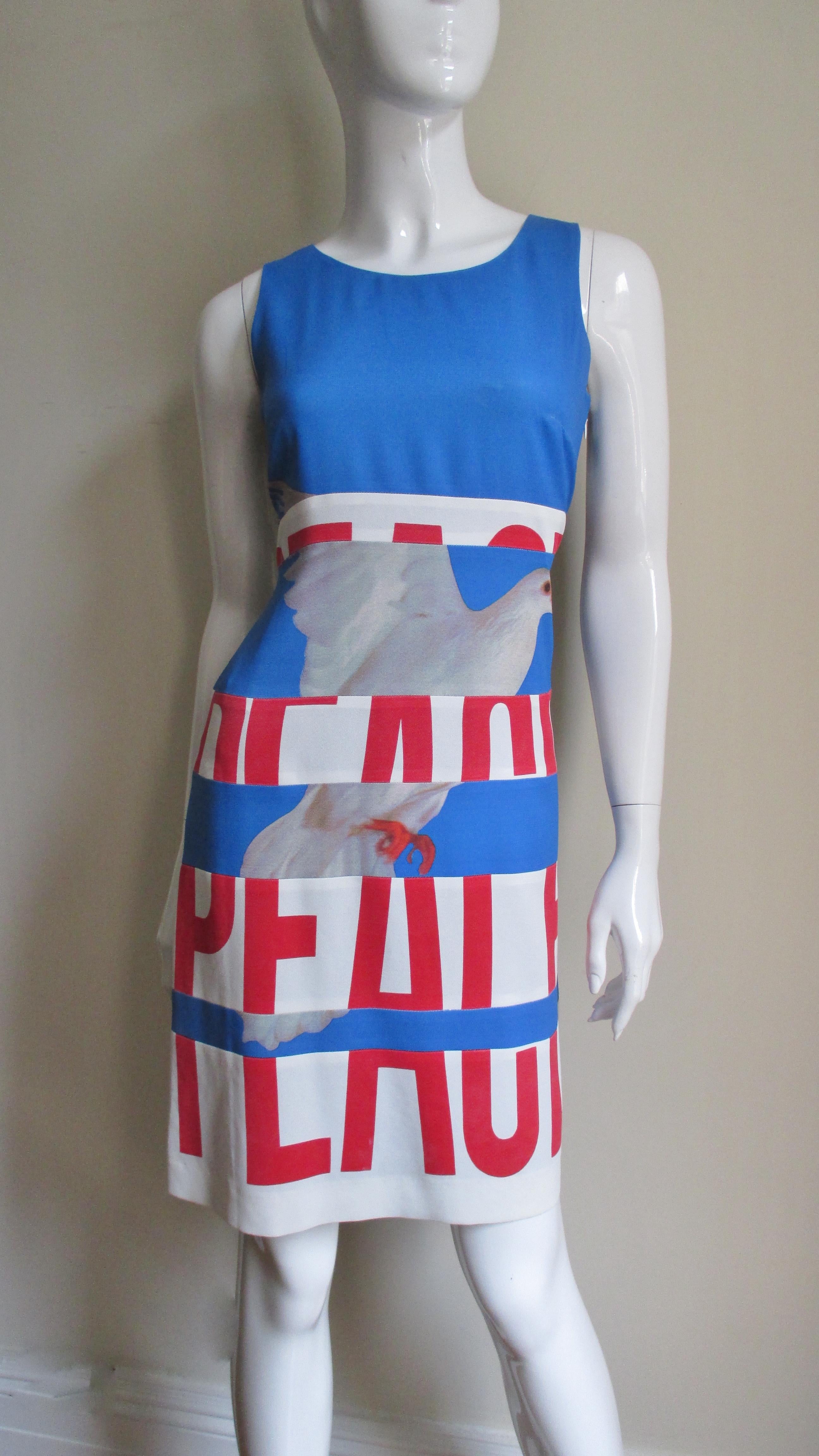 This is one of Moschino's most poignant dresses in bright blue emblazoned on the front in large red letters the word 