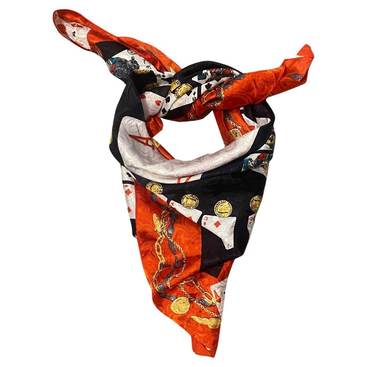 1990s Moschino Playing Cards Print scarf on main red color This lightweight, stylish scarf adds a fun pop of color to any outfit, and is sure to turn heads in any crowd.

Dimensions: 85cm x 85cm

Condition: vintage, 1990s, very good

This timeless