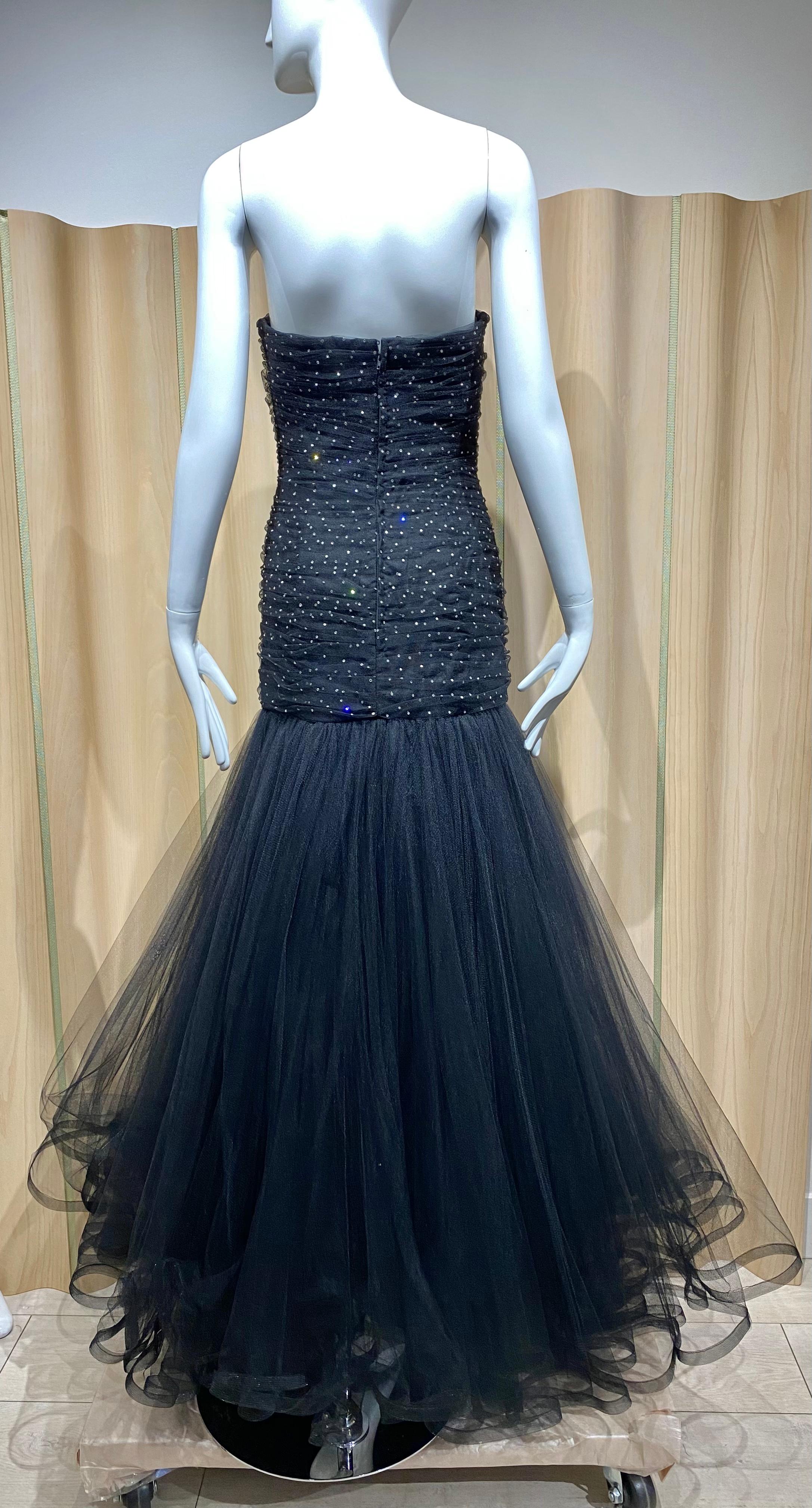 1990s Murray Arbeid from Bergdorf Goodman  strapless tulle gown as worn by Lady Diana ( see image) . Gown has 5 layers of tulle with silver stars sequins. Perfect for Holiday Party or Black tie event.
Size Small 
Measurement :
Bust 34”/ Waist 27”/