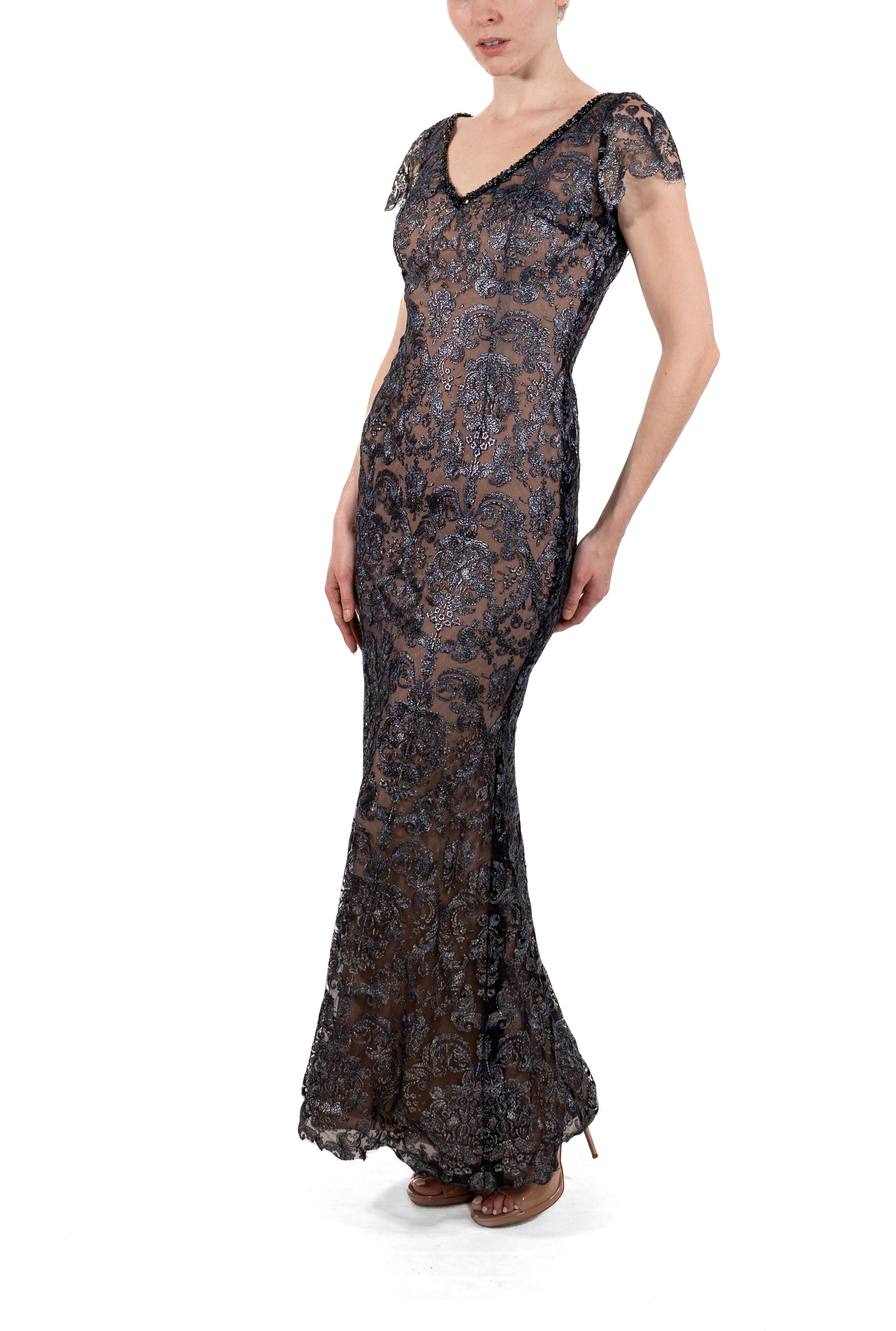 This gown retains no label, however the amount of hand-finishing points to Haute Couture or custom made quality, fully lined in silk. 1990S Navy Blue Metallic Rayon & Silk Lace Gown With Short Sleeves 