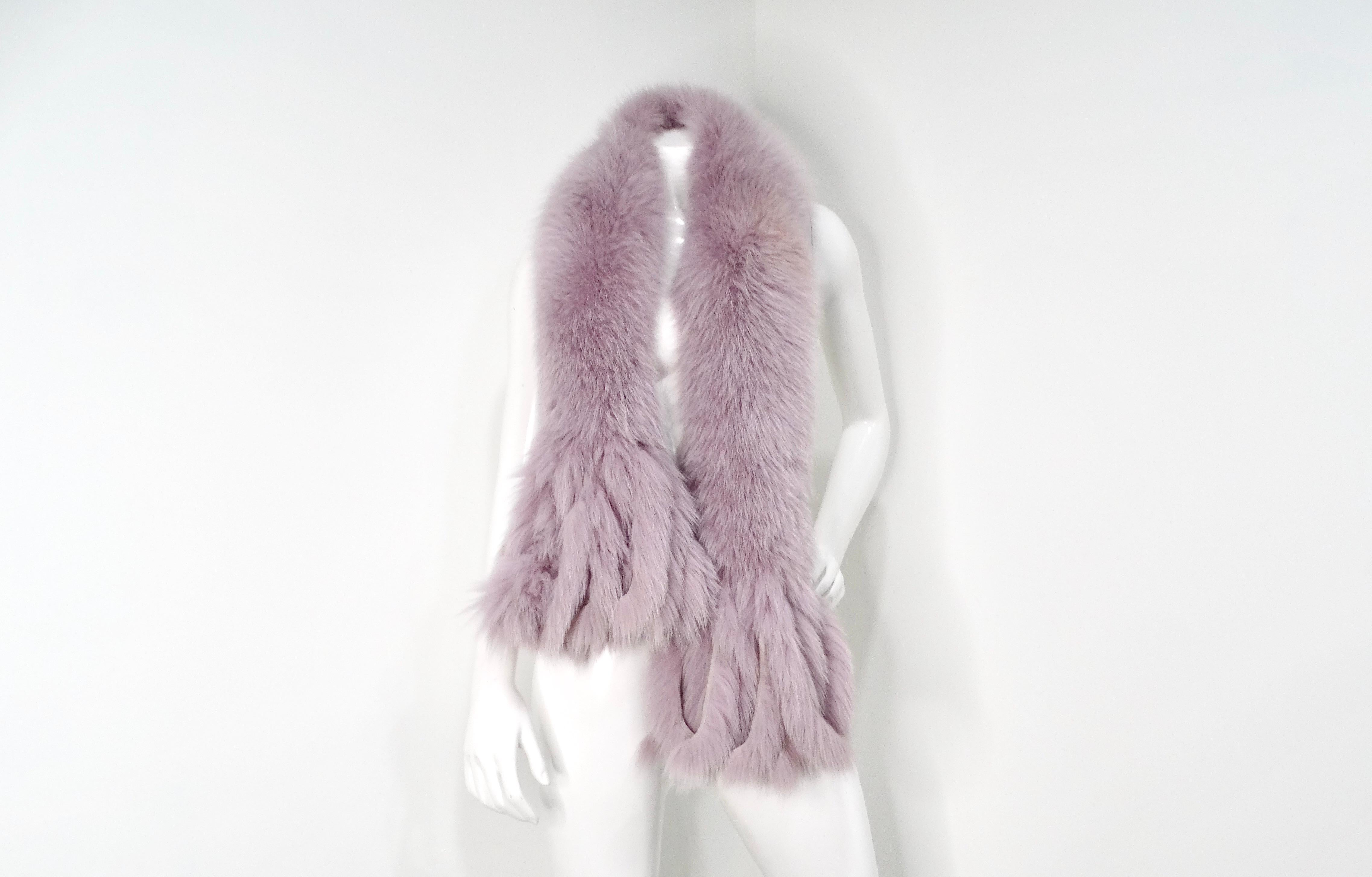 This exquisite 1990s Neiman Marcus Blush Purple Dyed Fox Fur Scarf is a stunning accessory, perfect for elevating any winter ensemble. The delicate blush purple hue adds a touch of softness and femininity, making it an ideal complement to a variety