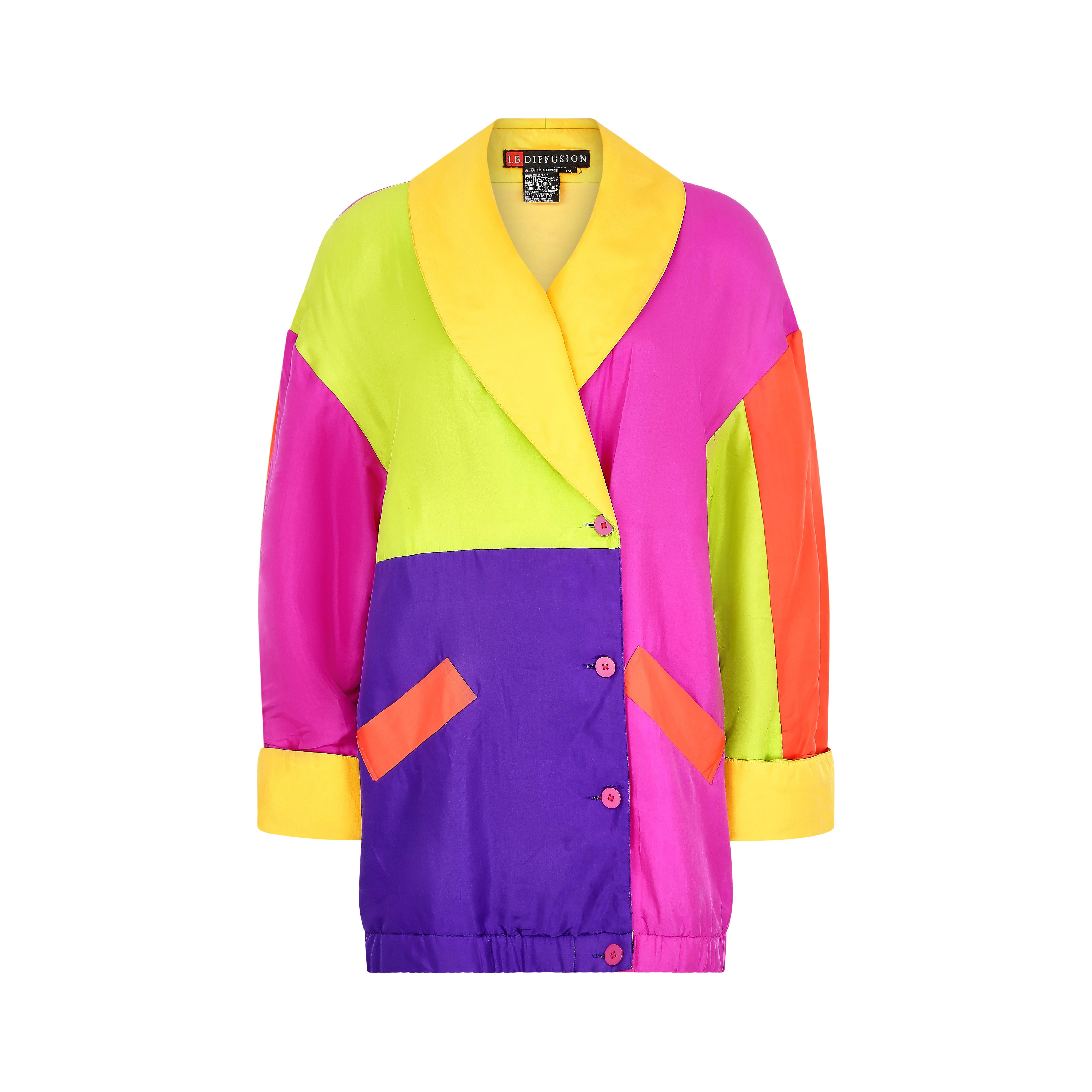 This is an outstanding multicoloured parka jacket dating to 1991, lightly padded and cut in an oversized bomber shape, with a large collar and turnback cuffs. The material is a very soft silk, with a colour block pattern featuring shades of hot