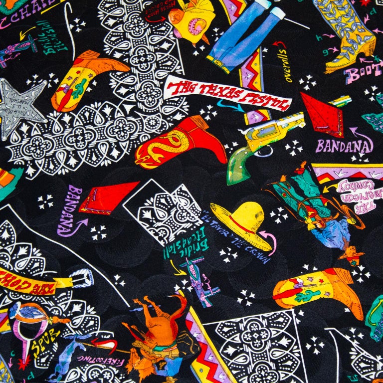 Very large Nicole Miller silk jacquard scarf from the 1990s. Black background with an all over multi colour Mexican cowboy print featuring cowboy boots, hats, guns, bandanas and all the stereotypical cowboy motifs. Hand rolled hem. Excellent vintage